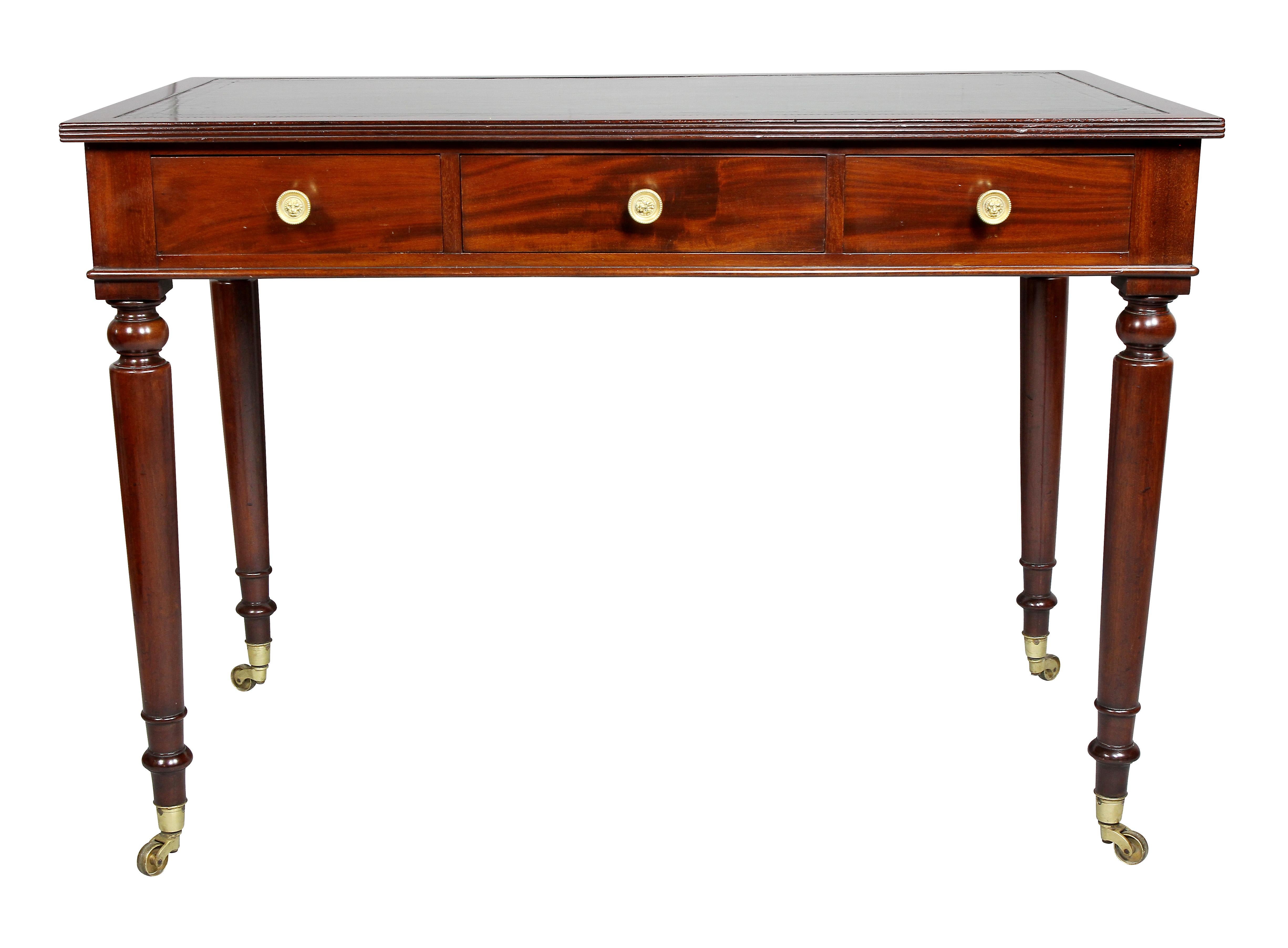 Bearing a stamp VR 1866, Windsor Castle, Room 449 with crown. Also a paper label VR 1866. Rectangular top with inset green leather over three drawers, lions head brass knobs, raise on circular tapered legs. Casters. Ex Christies NY.