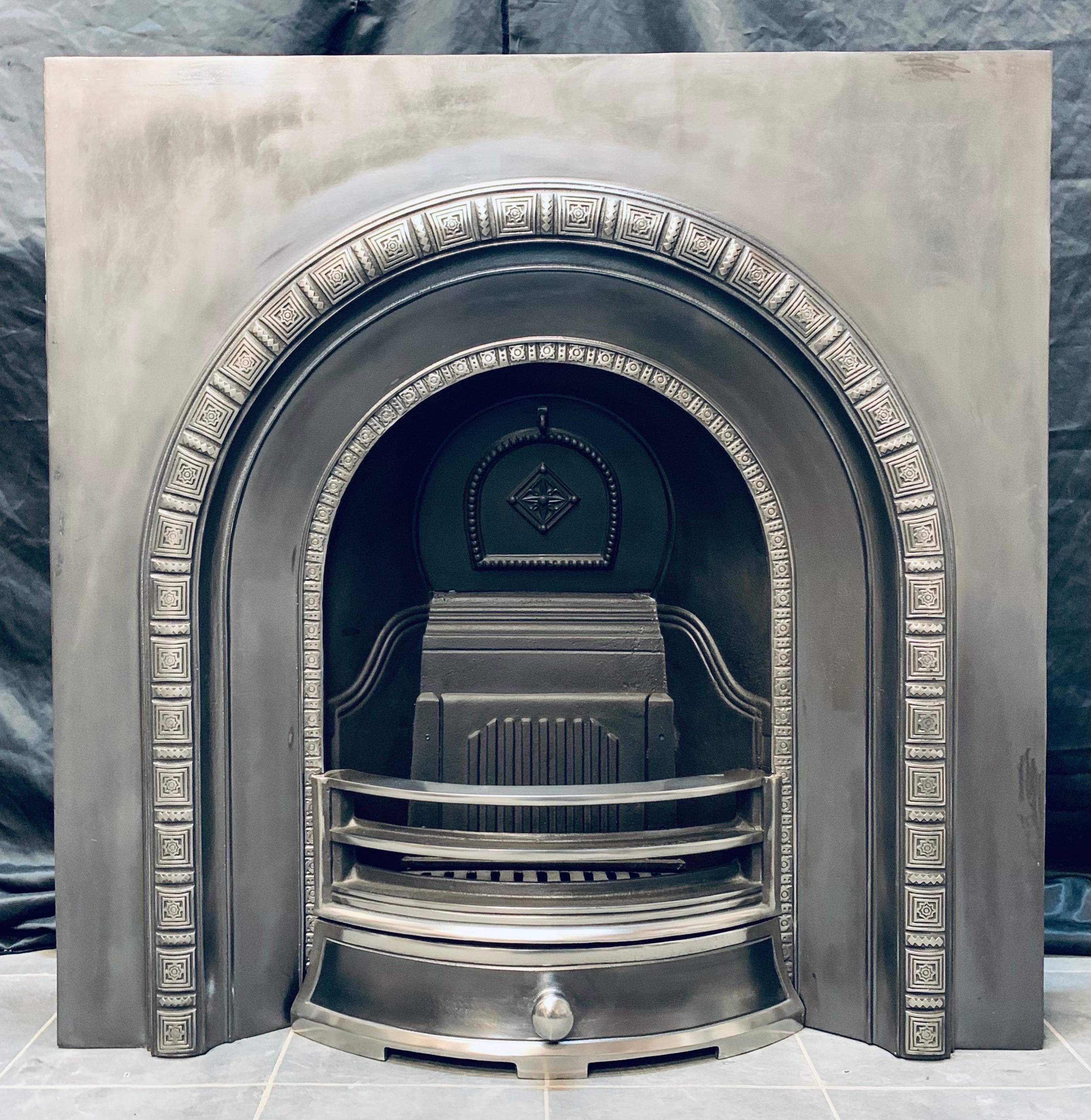 A versatile Victorian manner arched cast iron fireplace insert. A generous outer plate with a raised arched border, the three barred fire bars, with original curved ash pan door, decorative damper to back chamber. We have many fire surrounds that