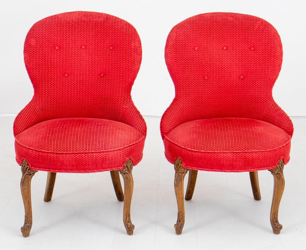 Pair of Victorian manner spoon back slipper chairs, each with shaped tufted back above upholstered seat, now covered in brick red chenille, above carved cabriole legs. 

Dealer: S138XX