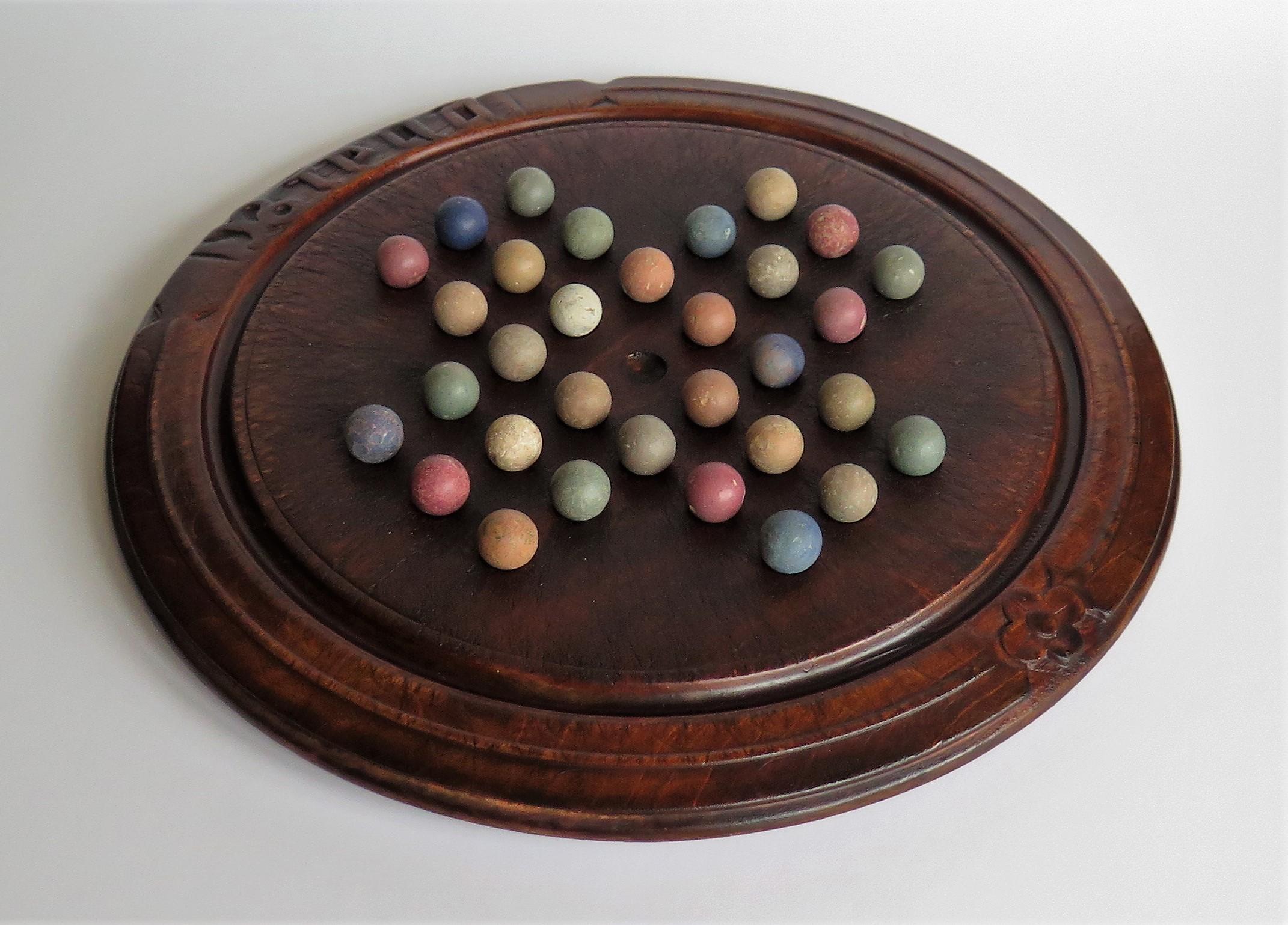 English Victorian Marble Solitaire Game with Converted Folk Art Carved Breadboard