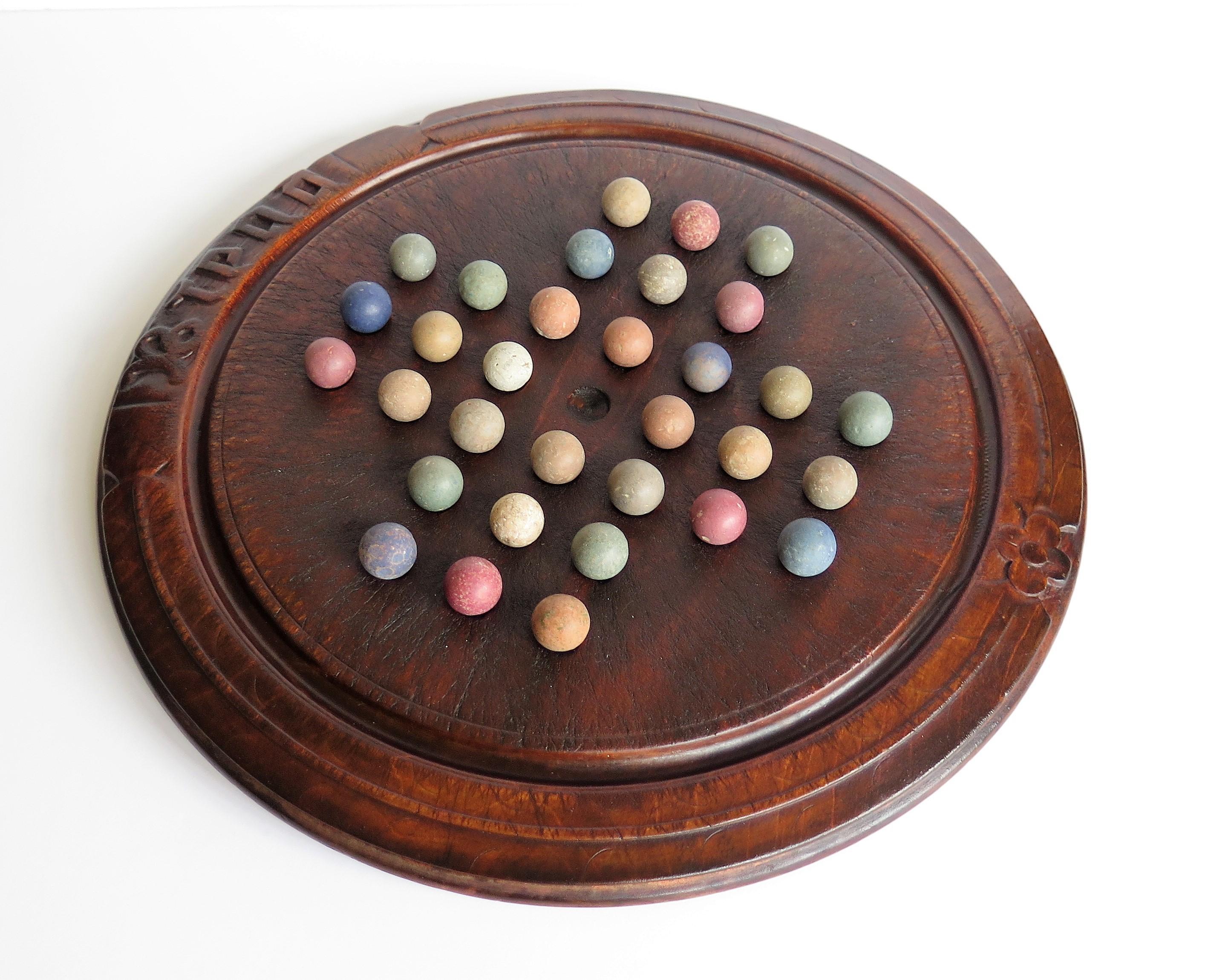 Hand-Crafted Victorian Marble Solitaire Game with Converted Folk Art Carved Breadboard