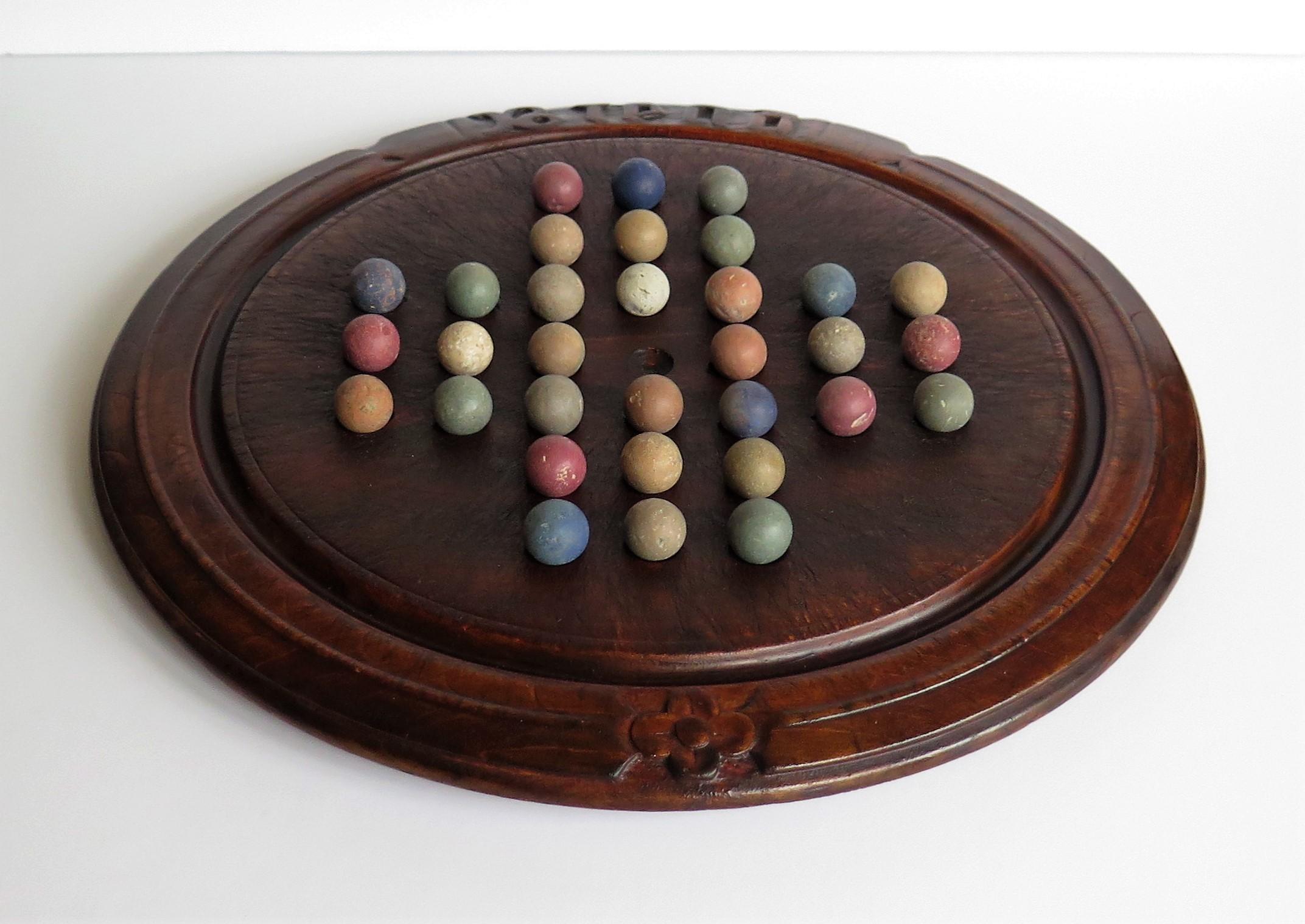 19th Century Victorian Marble Solitaire Game with Converted Folk Art Carved Breadboard