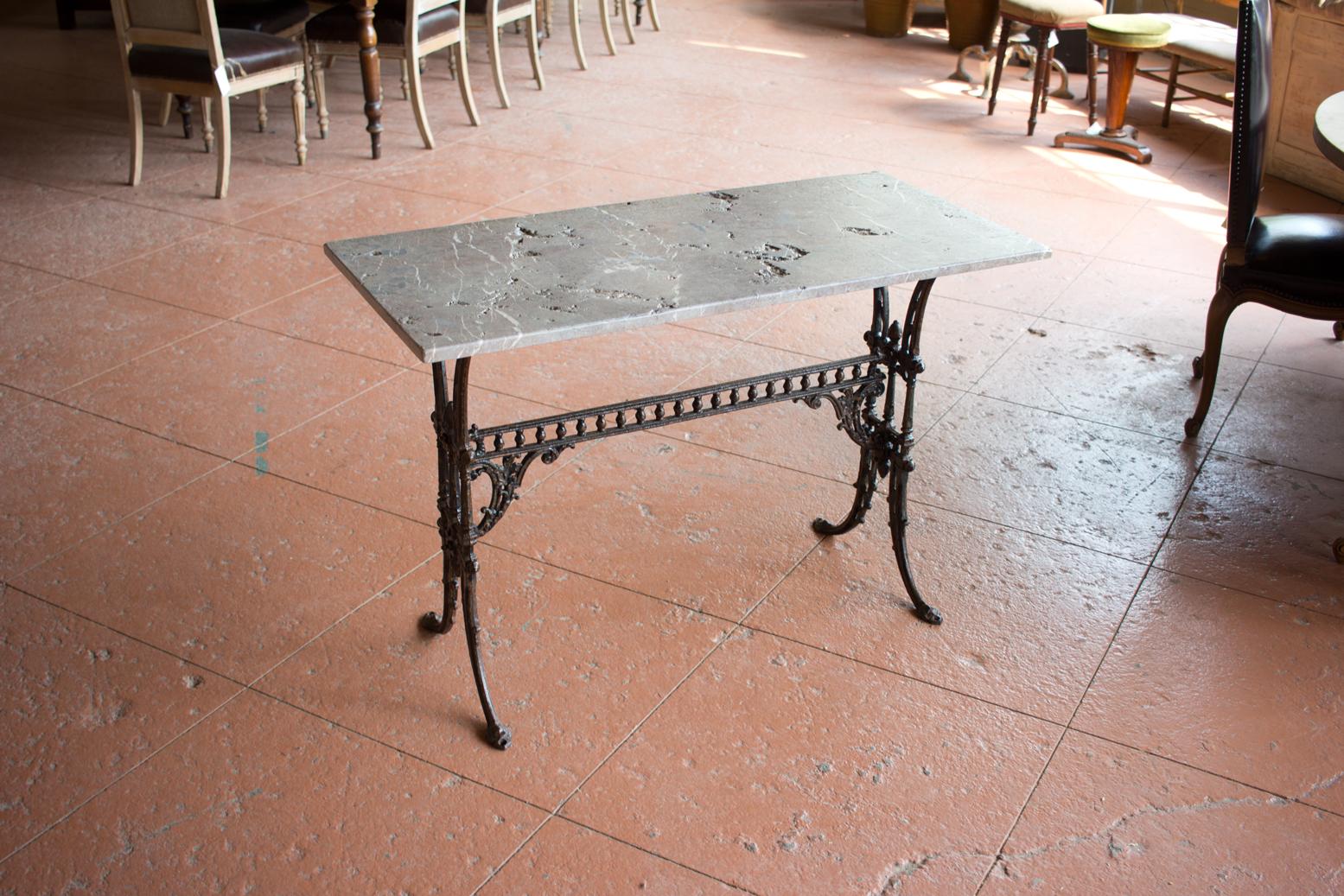 Victorian ornate garden table with wrought iron and topped with a beautiful marble slab with lots of distressing!