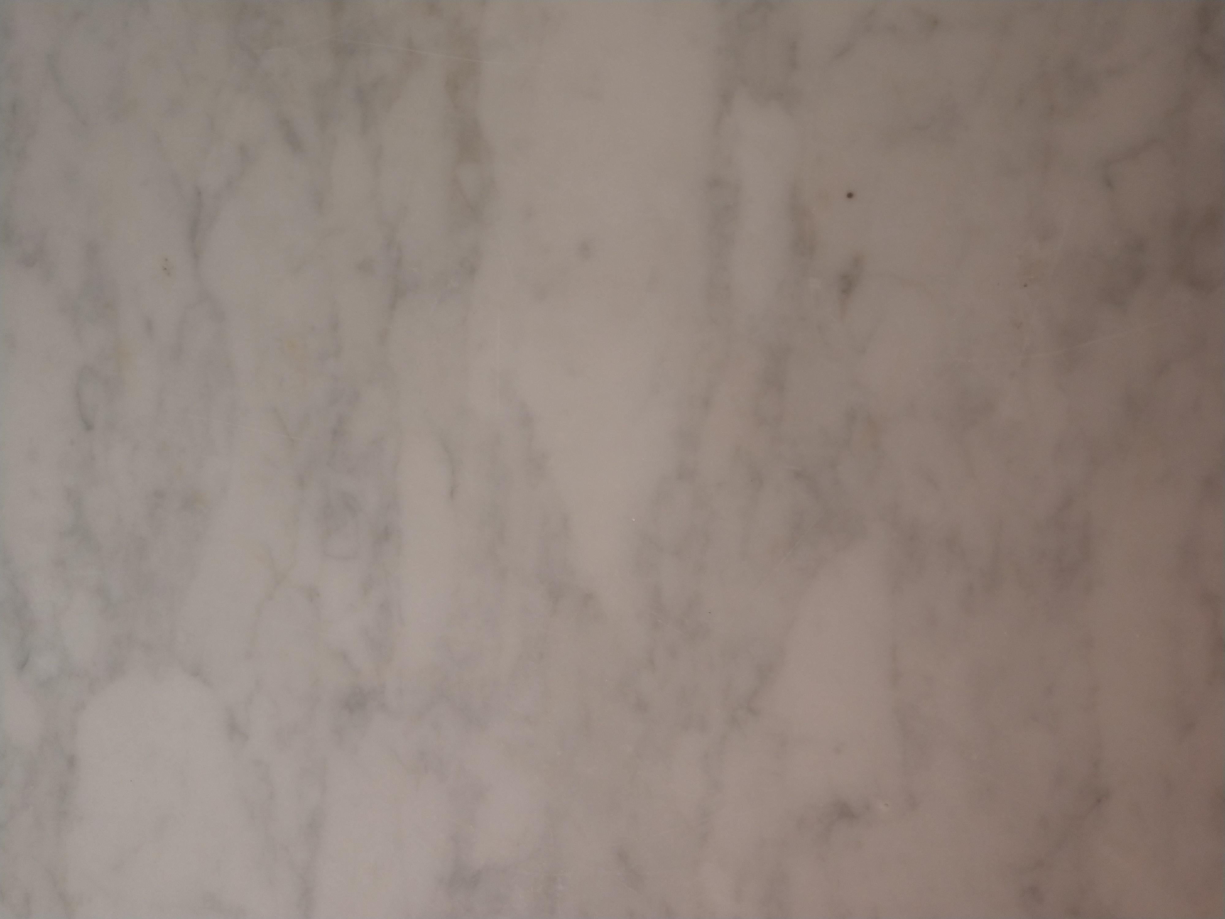 Very clean white Carrara marble-top table with a shaped edge.
Walnut base on original brass castor's. Some minor repairs to the base.