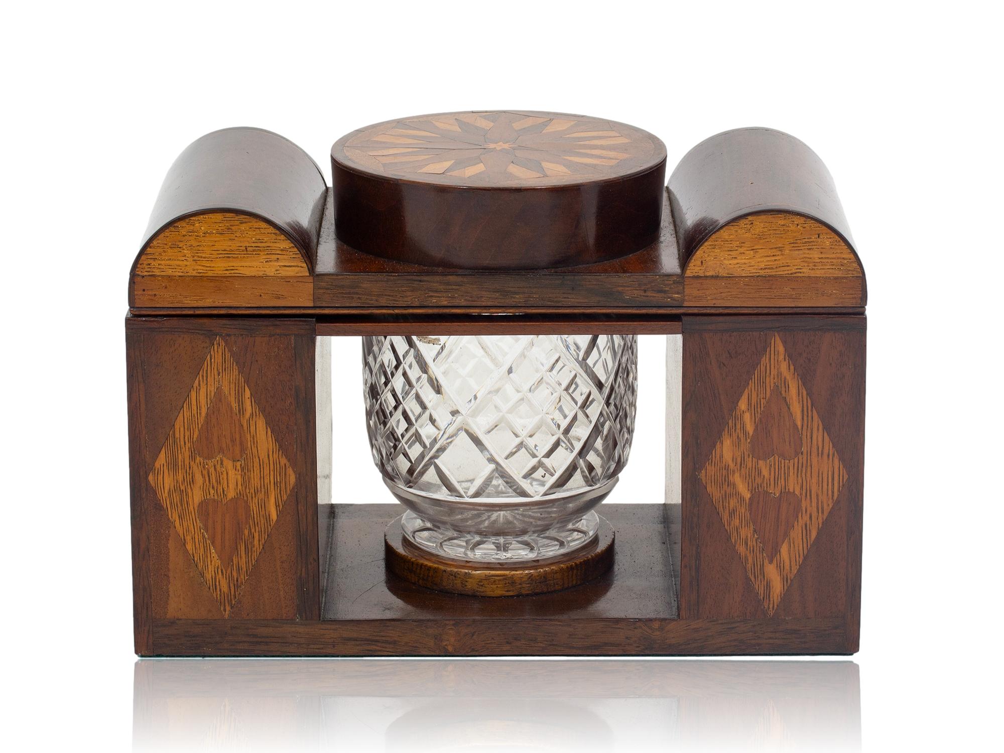 Featuring Inlaid Hearts and Diamonds

From our Tea Caddy collection we a pleased to offer this unusual Victorian Marquetry Tea Caddy. The Tea Caddy of unusual form with two outer Tea Caddies with domed lids and a central circular lid which houses
