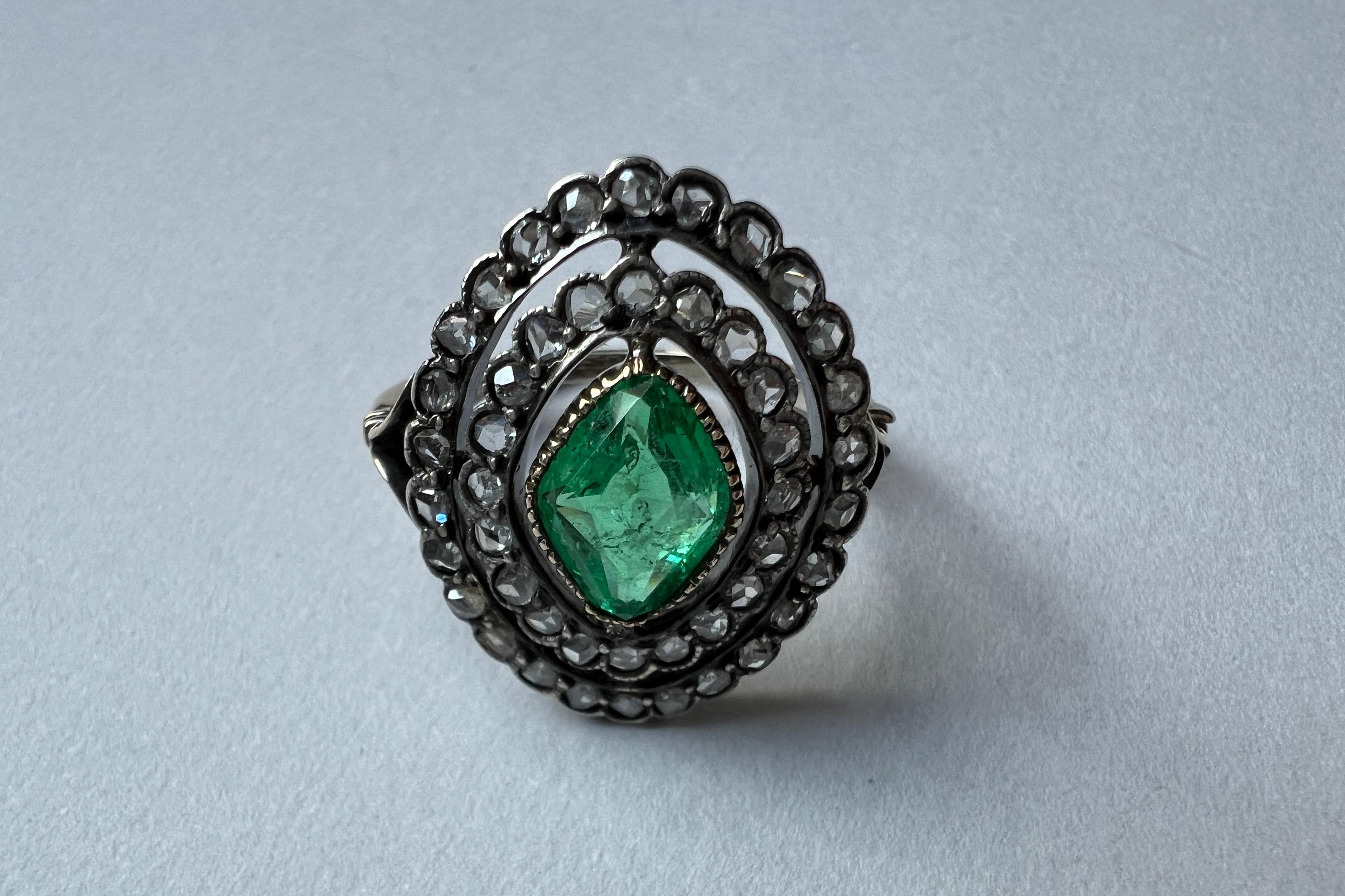 Antique Victorian Marquise Emerald cluster Diamonds Ring.
Dating from the late nineteenth century, the ring is crafted in 18kt yellow gold and silver. The double row of rose-cut diamonds for 0.69 ct aprox are set in a cluster with milligranate in