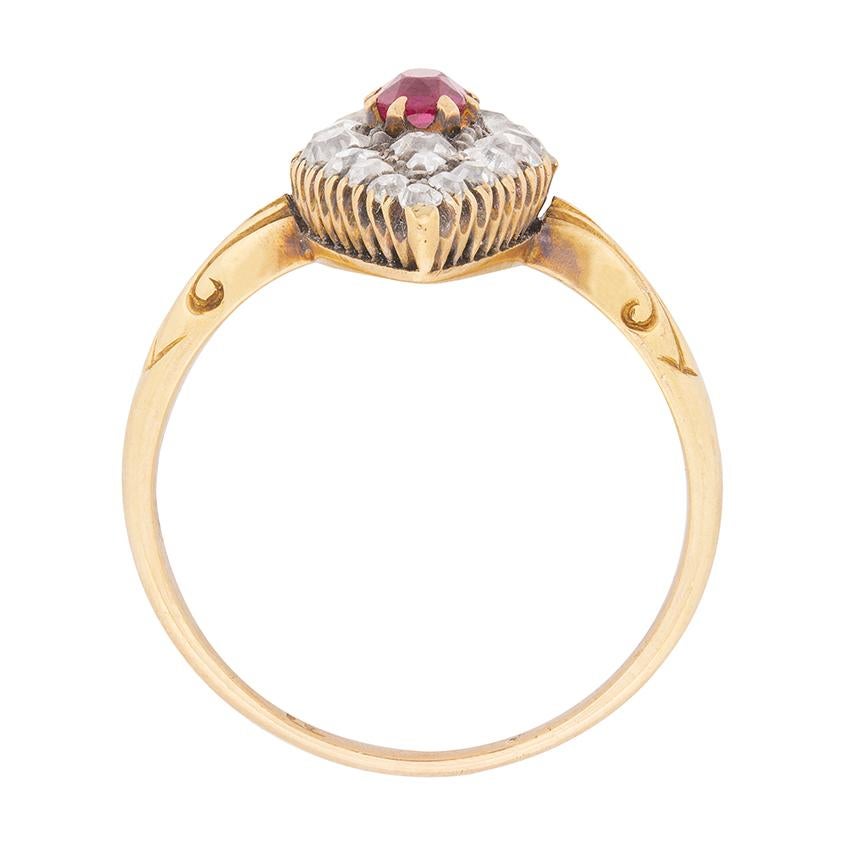 A marquise-shaped bezel centring a lush red ruby, and studded with 0.64ct old cut diamonds of varying sizes is the centerpiece of this Victorian era ruby and diamond cluster ring.

A pierced gallery and hand-carved shoulders, leading to a tapering