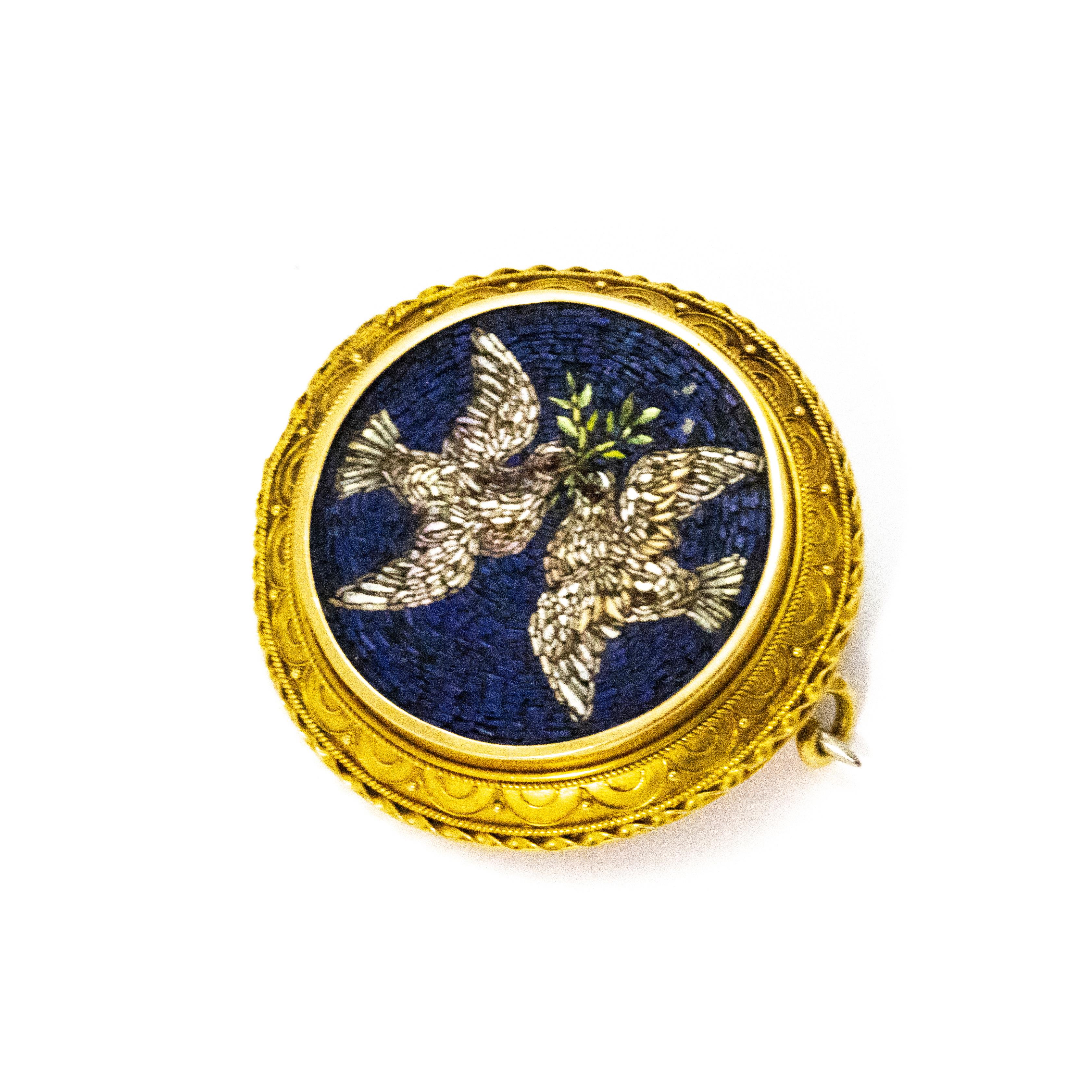 Stunning micro mosaic brooch with intricate 18ct gold setting and surround. Two doves are pictured with olive branches which symbolise peace.

Brooch Diameter: just under 1 1/2 inches