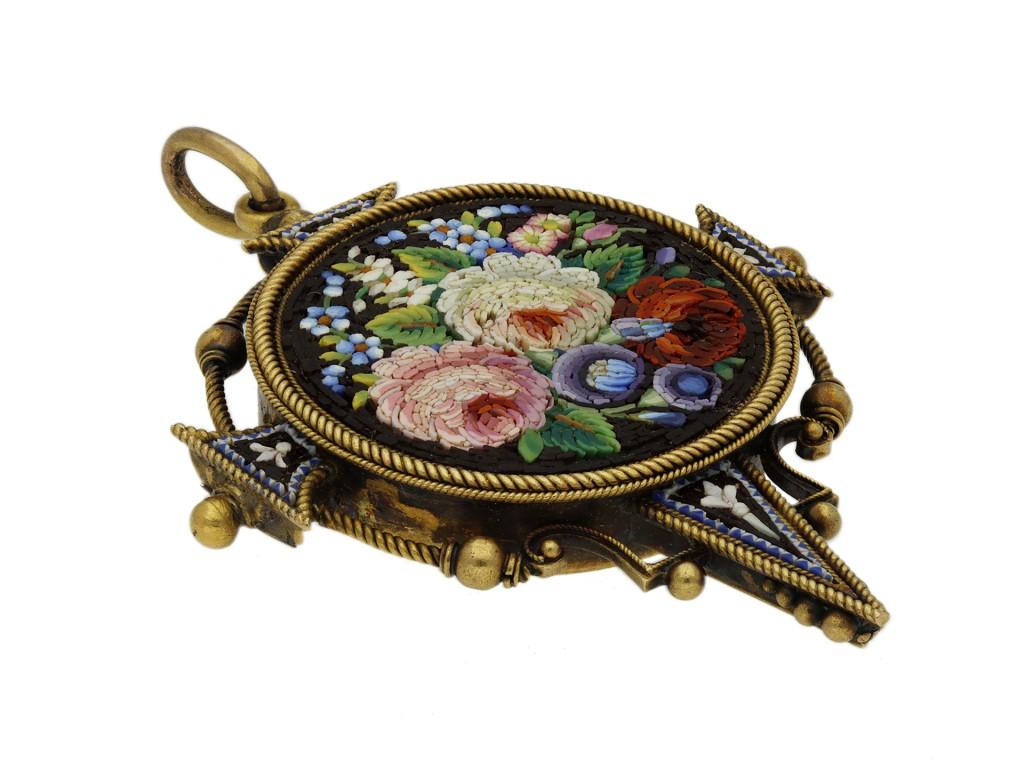 Victorian micro mosaic pendant. Set to centre with a circular panel of fine micro mosaic depicting a floral arrangement, further set to the cardinal points with micro mosaic fleur-de-lis motifs, to an ornate pendant design with openwork features,