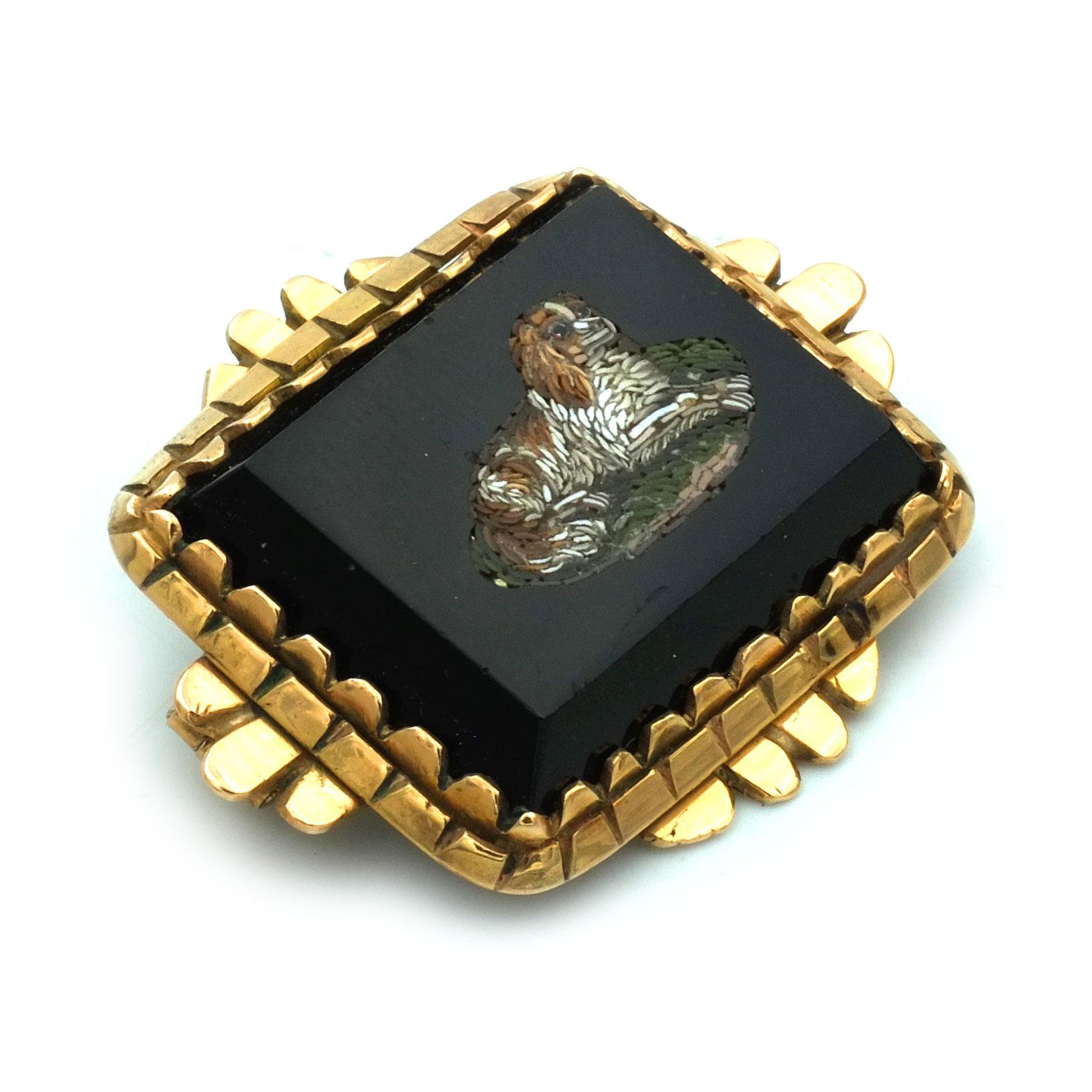 Victorian Micromosaic 14K Gold Brooch Depicting a King Charles Spaniel circa 1870

Delightful micromosaic brooch set in a gold frame. The fine inlaid work of colored glass mosaic on a black onyx depicting a lying dog, a little King Charles Spaniel.
