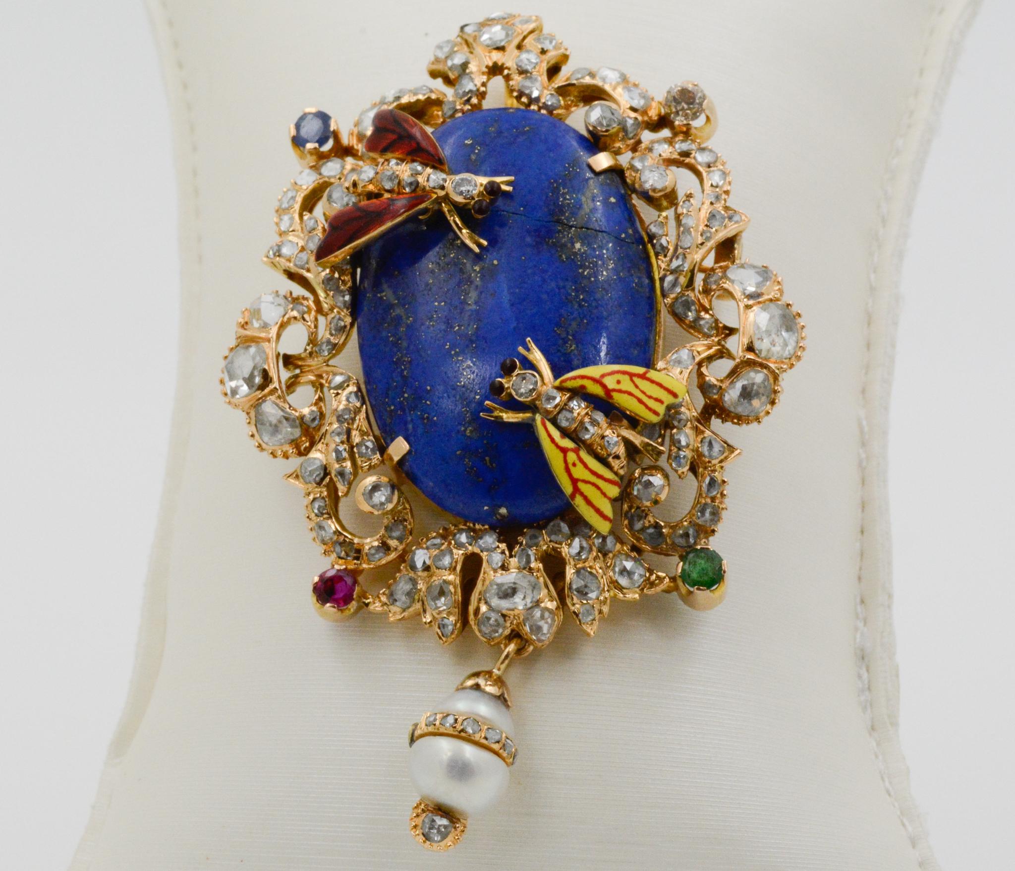 Exclusively from the Eiseman Estate Jewelry Collection, this early Victorian era Middle Eastern 14k yellow gold pin features a center oval lapis, 32.42x21.6mm. Surrounding the lapis is 3.00ctw of rose cut diamonds, J-K SI, one ruby (.30ctw), one
