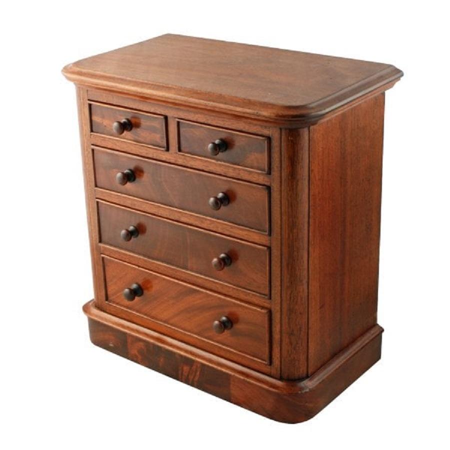 19th century Victorian mahogany miniature chest of drawers.


The chest has two small drawers over three long graduated drawers that are pine and mahogany lined and have a cock beaded edge.


The chest has a round moulded edge to the top and