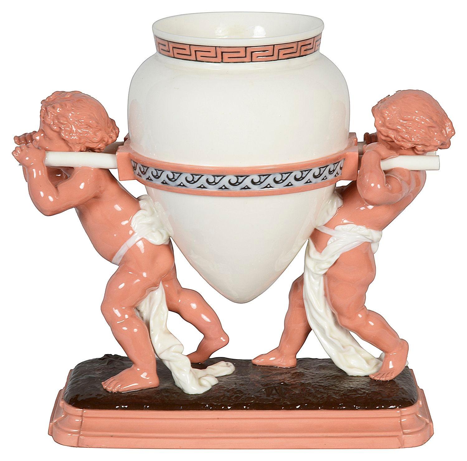An enchanting and very good quality Victorian 19th Century Minton porcelain centre piece, having two putti carrying a large vase.


Batch 75. N/H