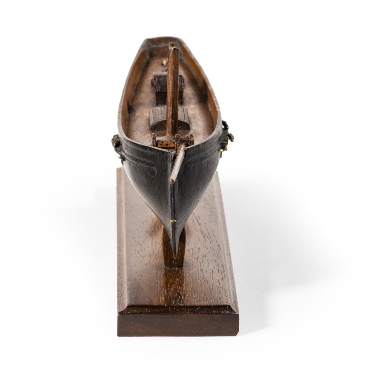 Victorian model of a racing yacht, with brass fittings, on a wooden stand original paint topsides English, circa 1870.