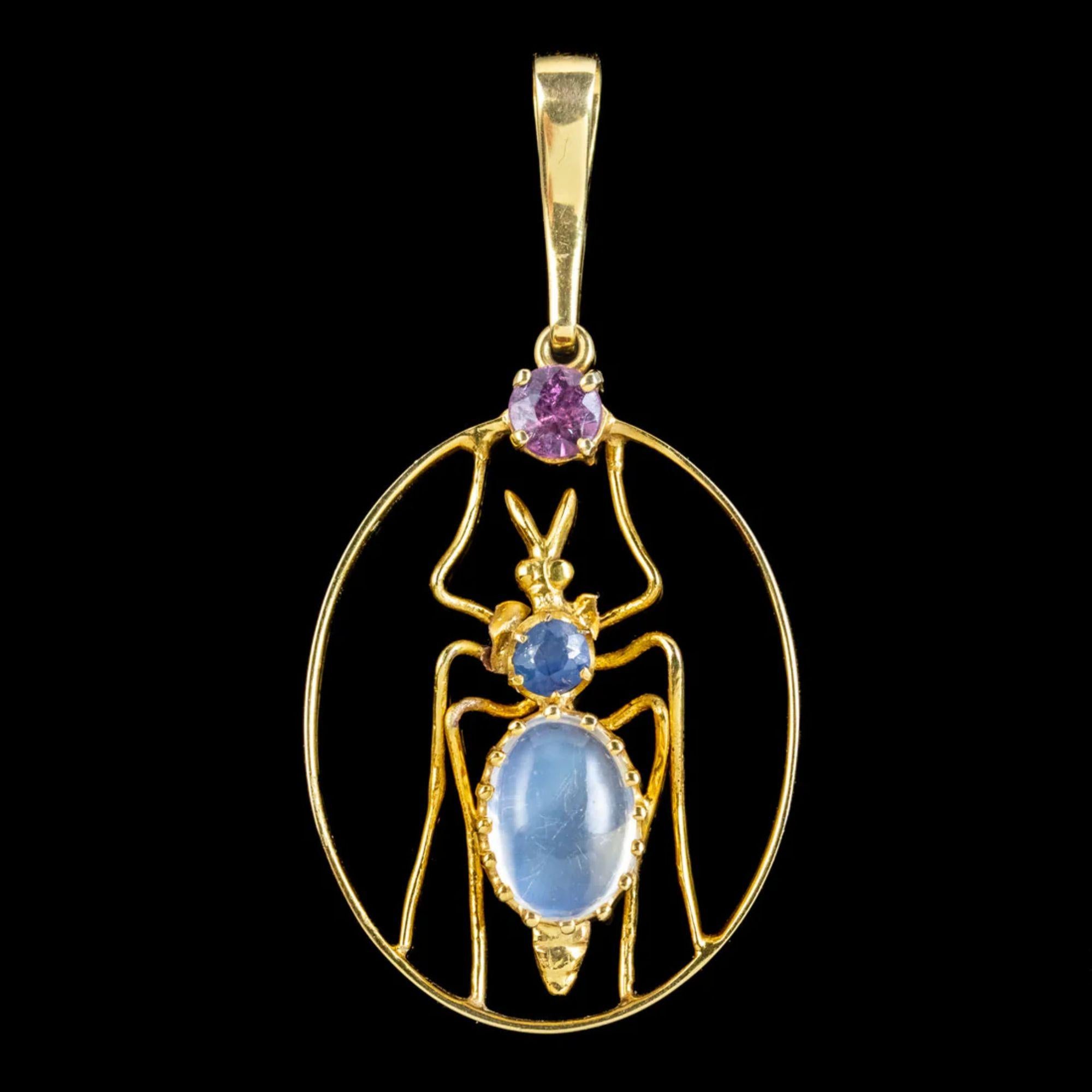A fabulous antique Victorian pendant from the late 19th Century featuring a colourful insect claw set with a glowing cabochon moonstone abdomen (approx. 1.3ct) and a blue sapphire thorax, with a violet amethyst resting at the top. 

Insect jewellery