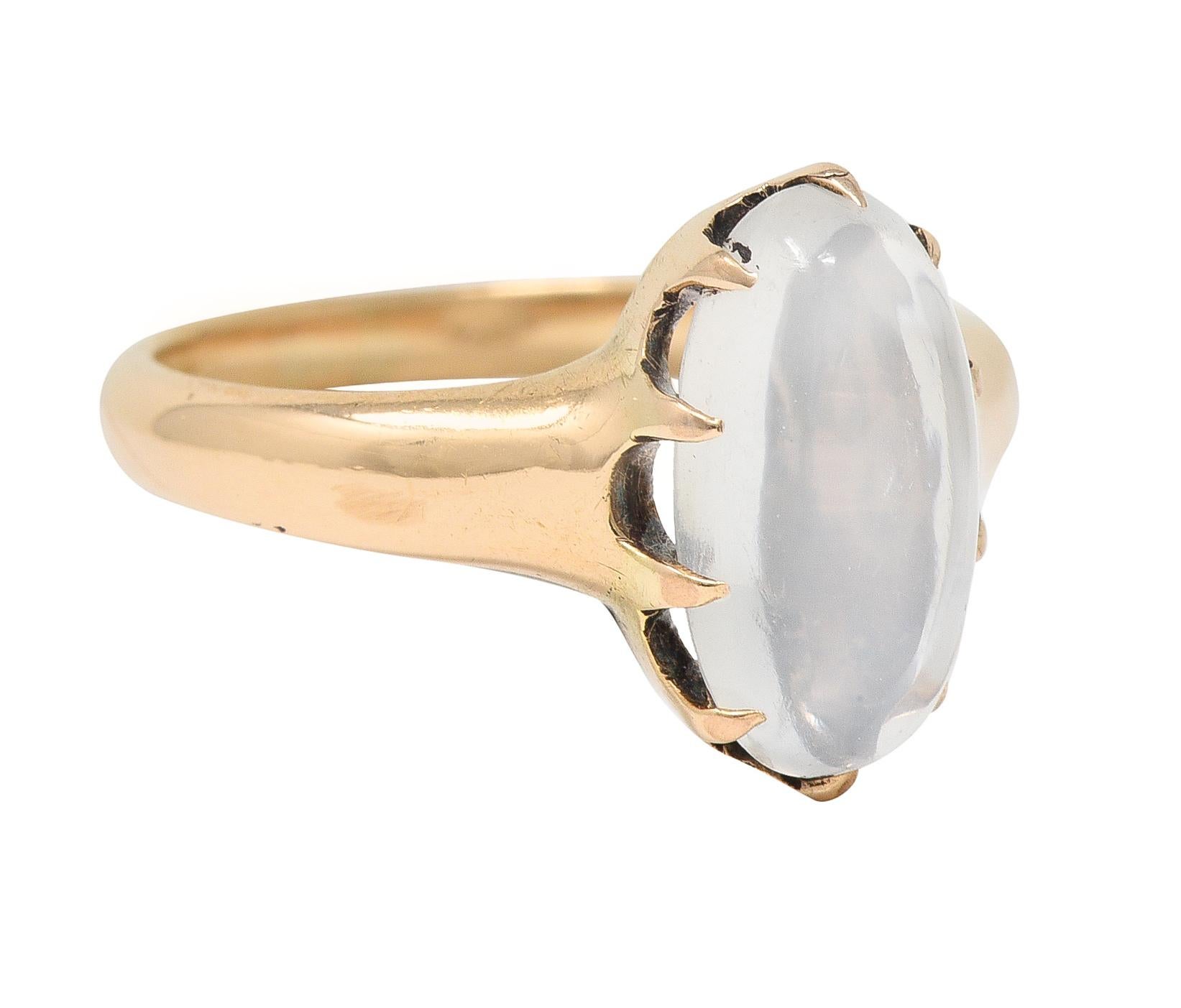 Centering an oval-shaped moonstone cabochon measuring 6.0 x 12.0 mm 
Translucent colorless body with white adularescence 
Set with belcher-style prongs 
With high polish finish
Stamped for 14 karat gold
Circa: 1880s
Ring size: 4 3/4 and