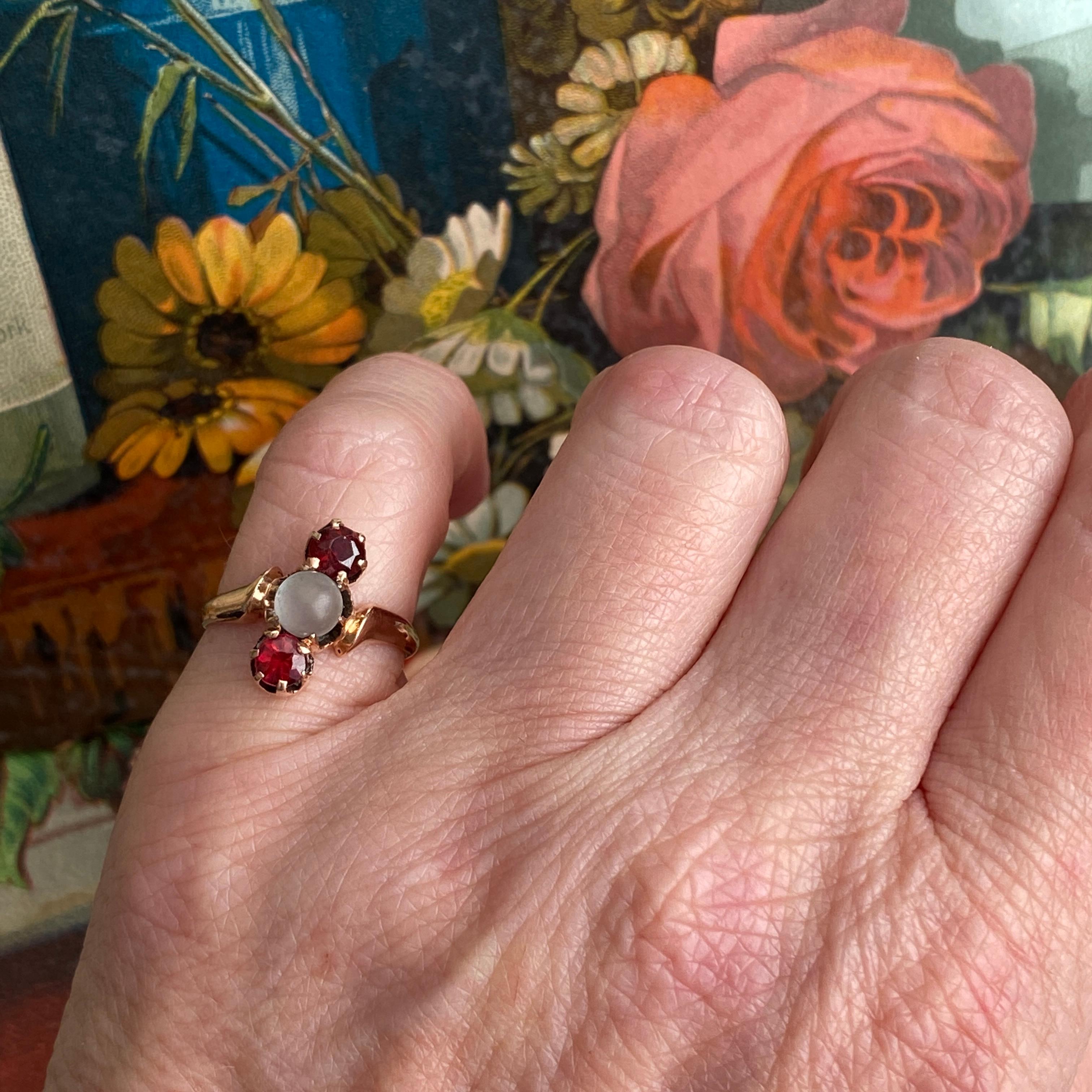 Details:
Super sweet Victorian ring with moonstone and red garnets. Classic three stone setting with lots of character. The red on the garnets is a nice pretty true red! The ring is 14K rose gold, and has a smooth shoulders. There is 1—5mm orb