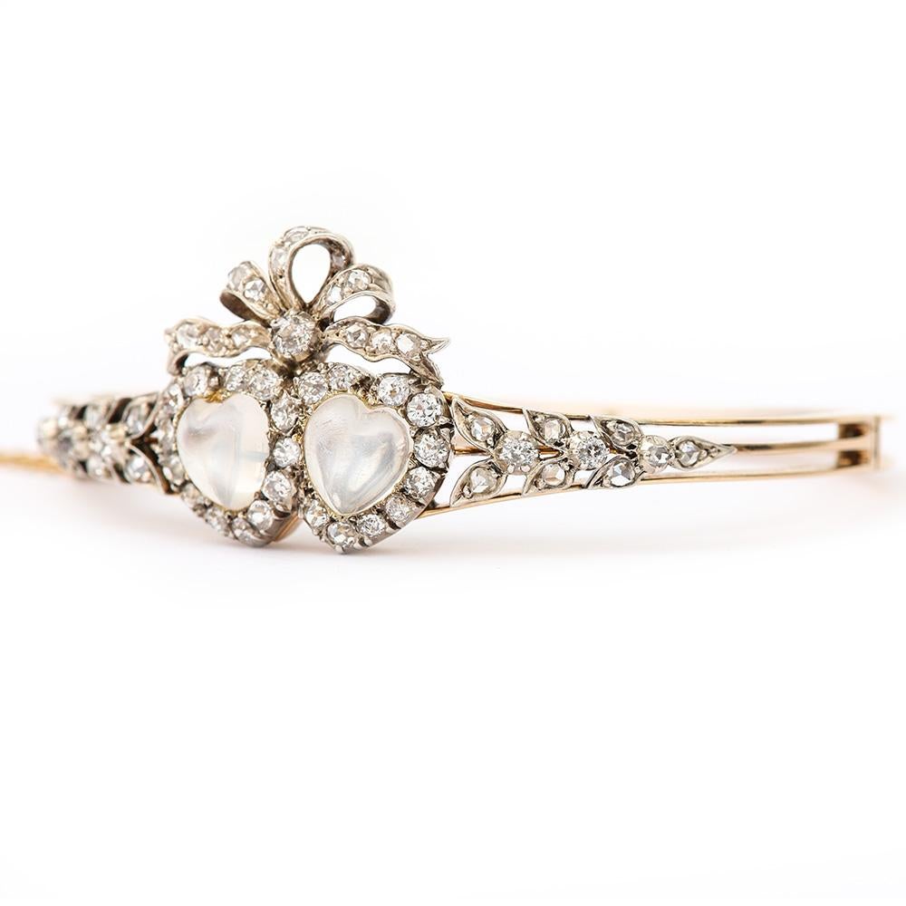 A beautiful Victorian carved moonstone and diamond bangle. A super example of this very pretty antique design popular during the late Victorian period (1870 - 1900) as these sentimental pieces were very much in vogue at the time. The heart is