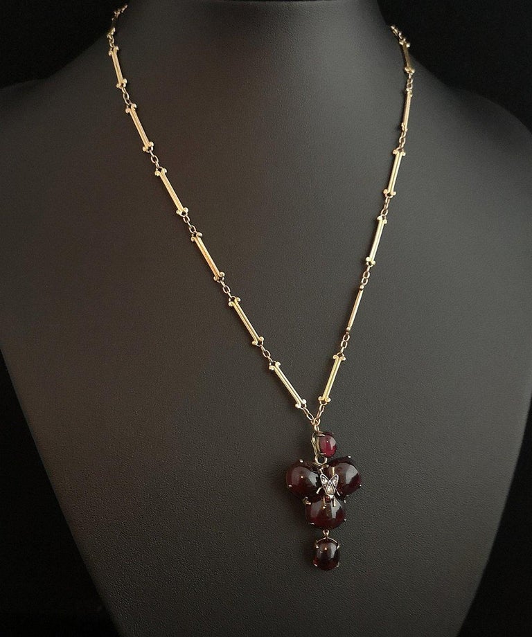 A beautiful and rare antique, Victorian era mourning pendant and necklace.

Made up from luscious rich, juicy bohemian garnet cabochons in a trefoil pattern, the centre is set with a diamond studded fly which has garnet eyes.

From the central