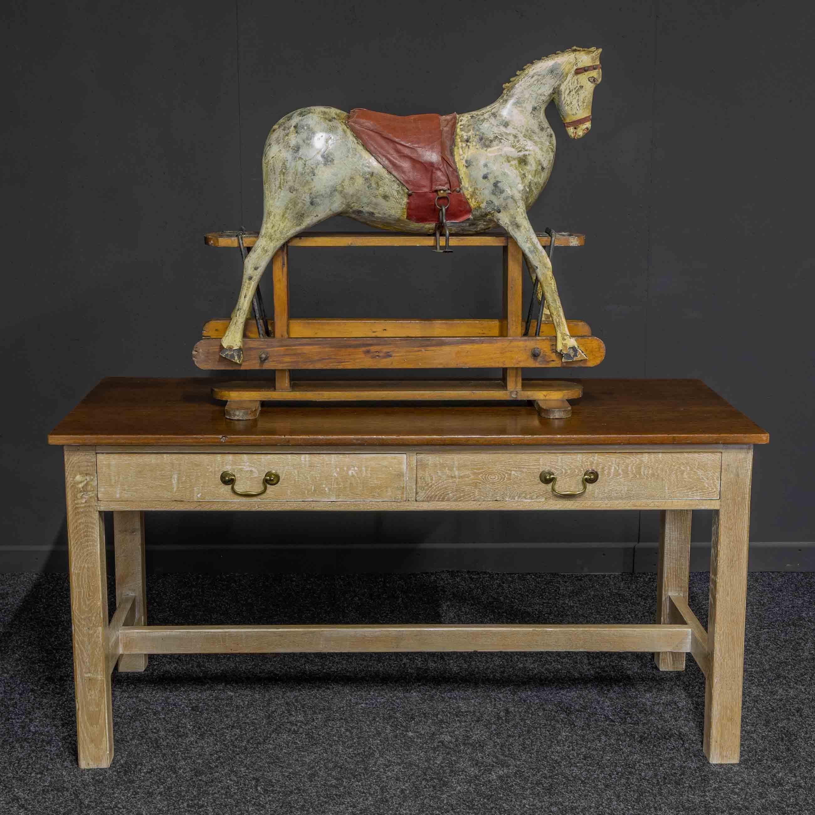 A most interesting and rare rocking horse that appears to be homemade and an attempt to copy an 18th century horse portrait. Hence the small head and large body. The actual construction of the horse and stand is very good and make us think that this