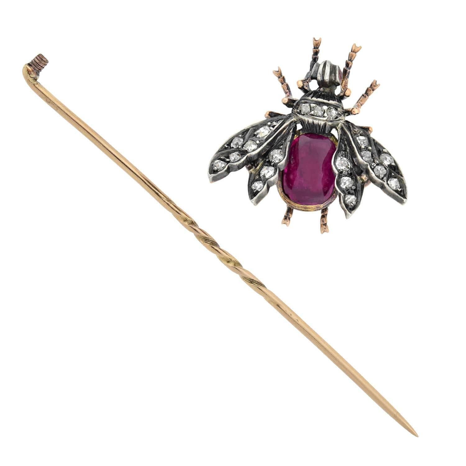 An incredible stick pin/pendant from the Victorian (ca1880s) era! Crafted in 18kt yellow gold and topped in sterling silver, this detailed fly boasts an approximate 1.25ctw natural Burma ruby set within its abdomen. Approximately 0.50ctw of