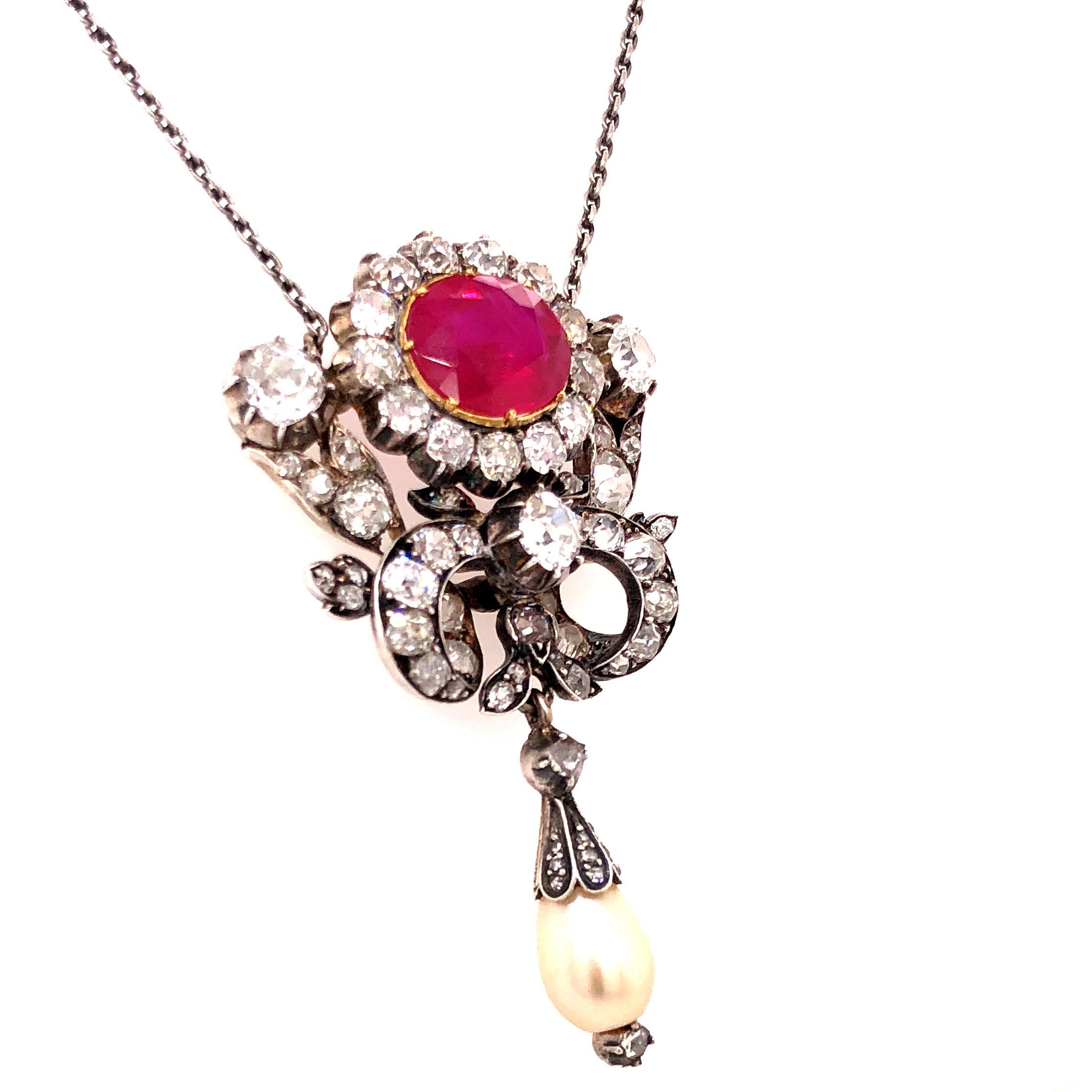 An important Victorian pendant with a ruby, diamond and a pearl, 1880s. The big centre stone is a rare natural and not heat treated Burmese ruby weighing 4.32 carats, certified by a Swiss gemological laboratory (SSEF), with a stunning red colour.