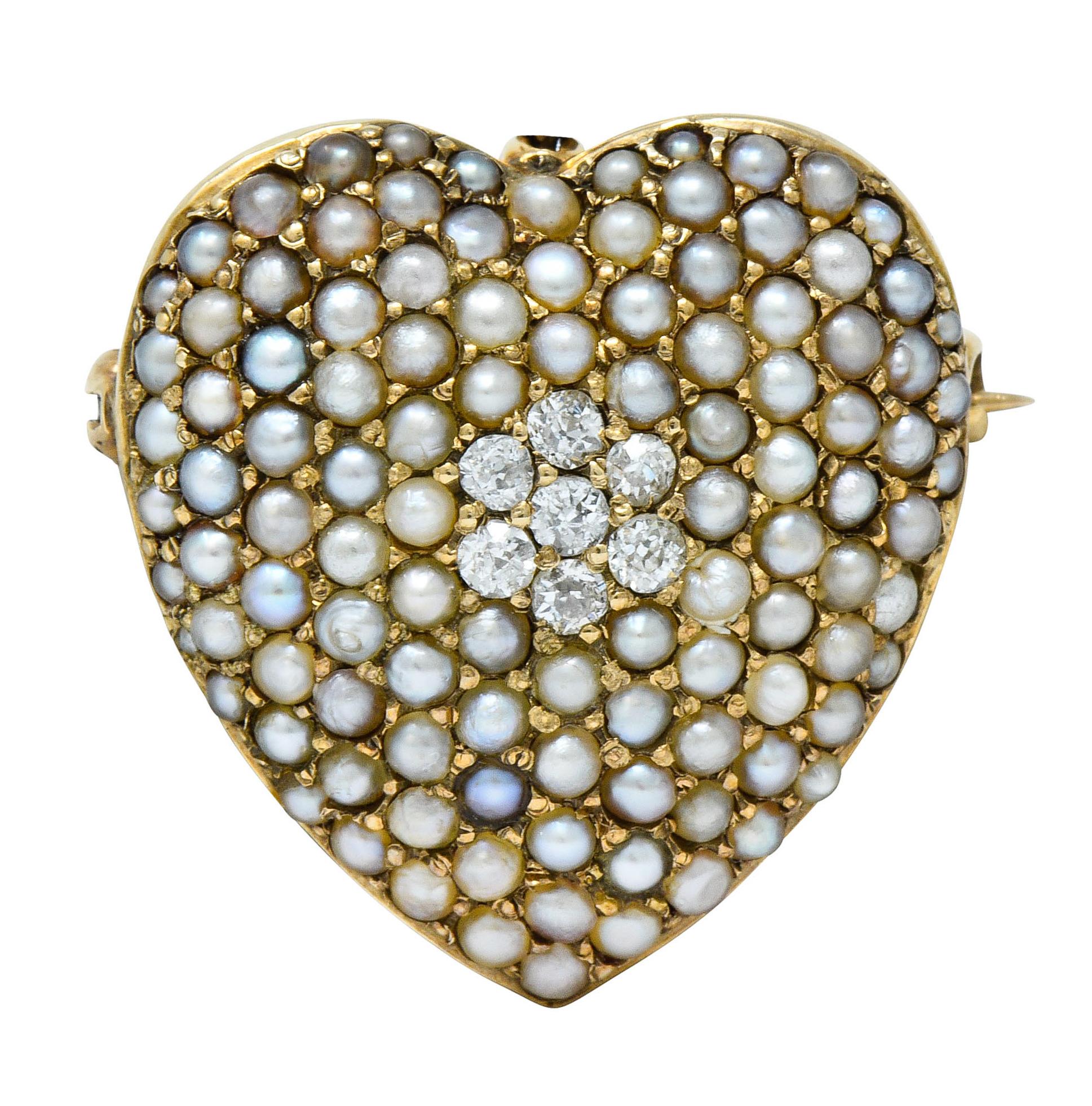 Designed as a heart pavéd throughout by 2.0 mm natural freshwater seed pearls, ranged in color and quality

Centering a cluster of old European cut diamonds weighing in total approximately 0.30 carat; I to J color with quality consistent with