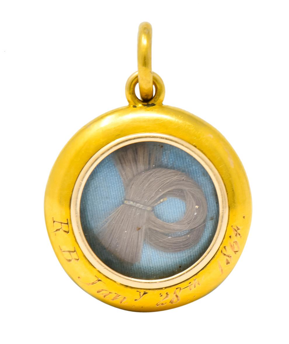 Featuring a round Victorian pendant with etched gold ribboning and turquoise enamel

Accented with a 4mm natural pearl with good luster and rose overtones

Reverse of pendant contains a compartment with turquoise blue material and lock of