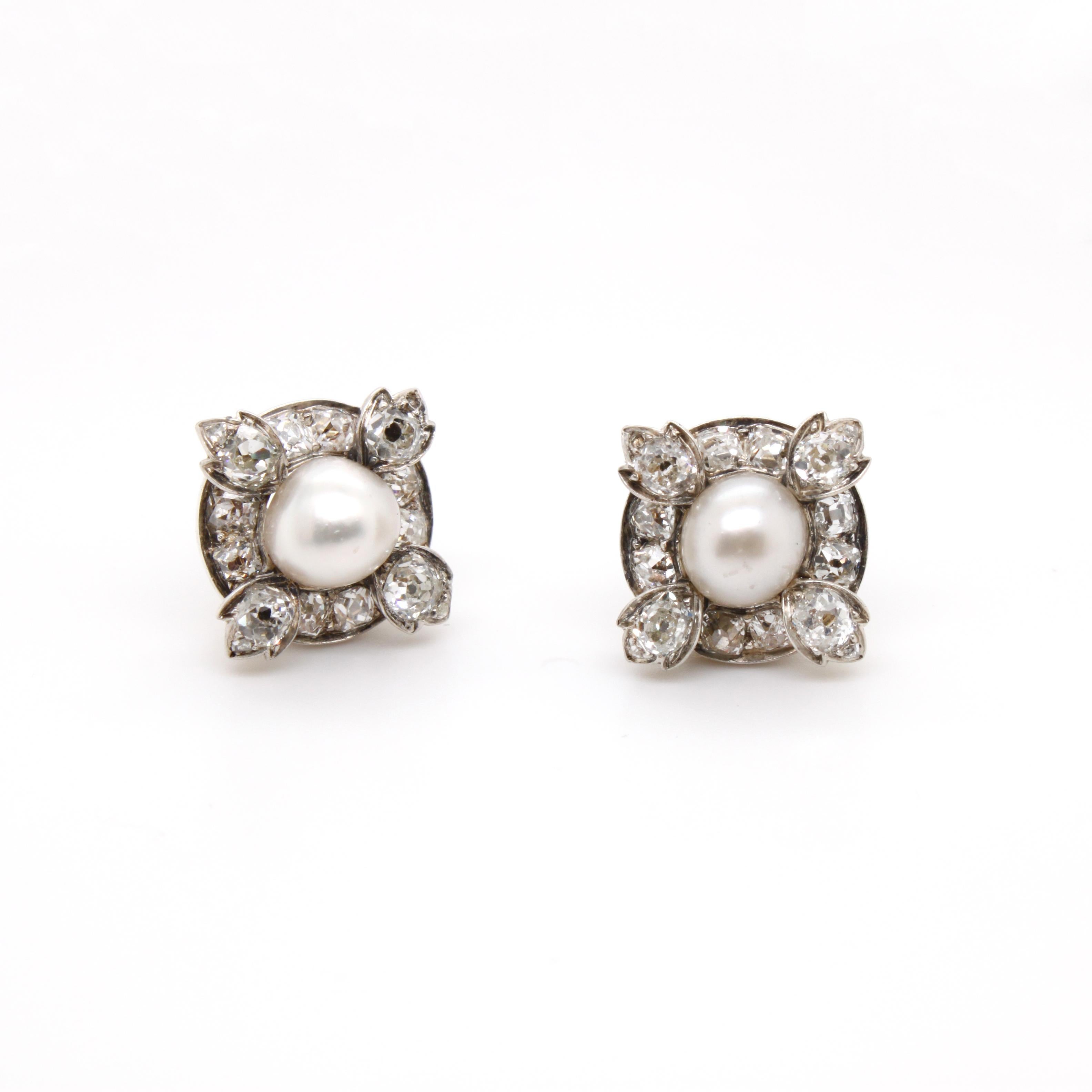 Victorian Natural Pearl and Diamond Cluster Earrings, ca. 1880s  

A beautiful pair of natural pearl and diamond cluster earrings, each with a natural saltwater pearl bouton of 7mm (tested, GCS), surrounded by a floral cluster of ca. 2 carats