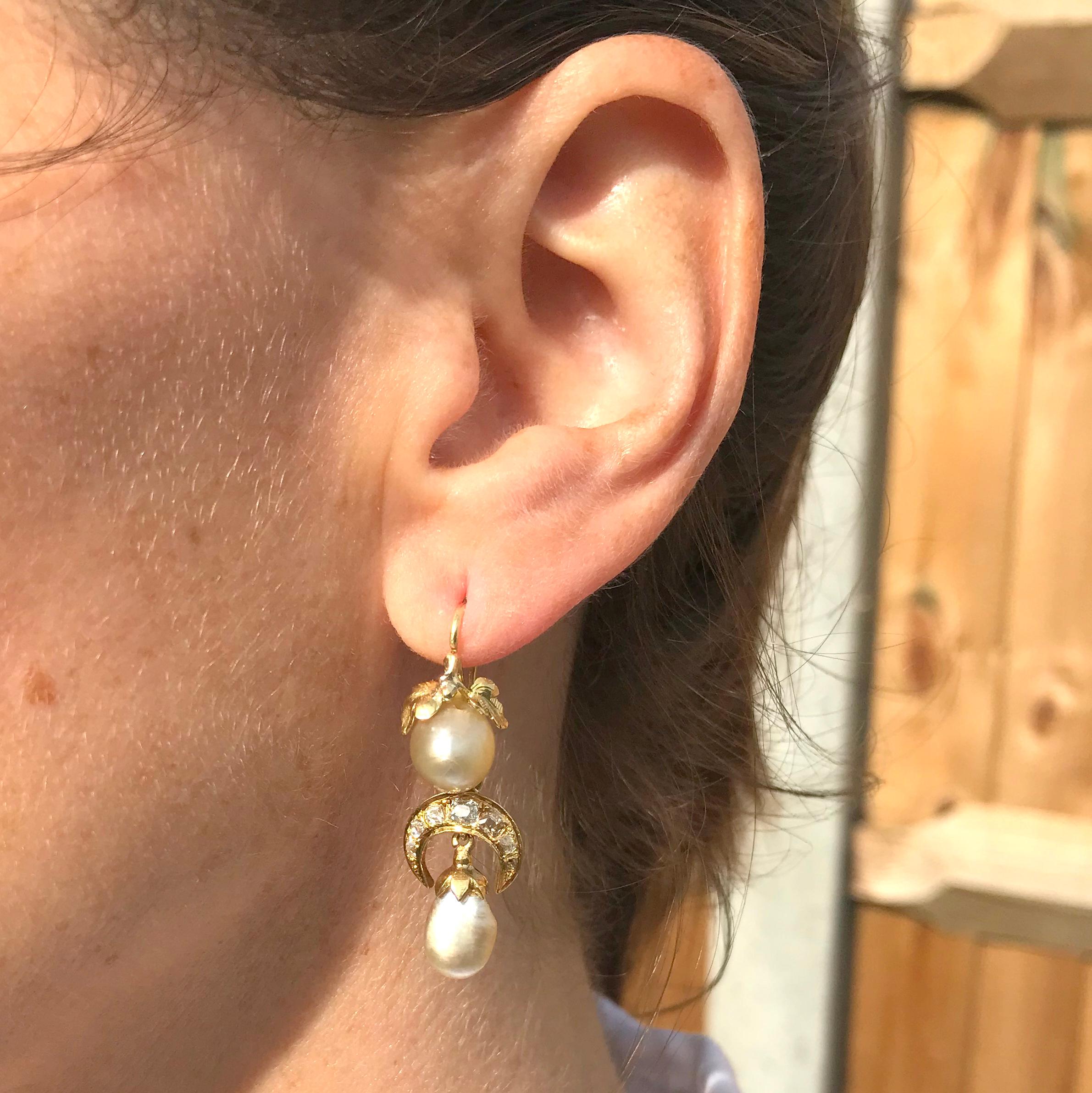 Breathtaking natural pearl earrings which can be worn long with the diamond and pearl drops, or just as the tops alone. Each earring is adorned at the top with a pair of beautifully realised leaves, with the articulated bottom part of the earrings