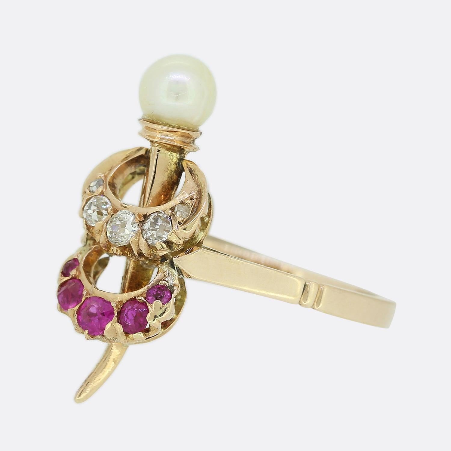 This is an 18ct rose gold diamond, pearl and ruby ring. The ring consists of two crescent moons, one of which is set with diamonds and the other with rubies. There is also a spear going through both of the crescents and the ring has been crafted in