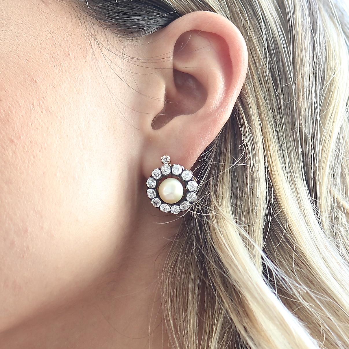 The everlasting bloom of nature captured with these natural pearl earrings. Featuring GIA certified natural salt water pearls that are surrounded by halos of old cut diamonds. Hand crafted in 18k gold resting on floating backs. Accompanied with the