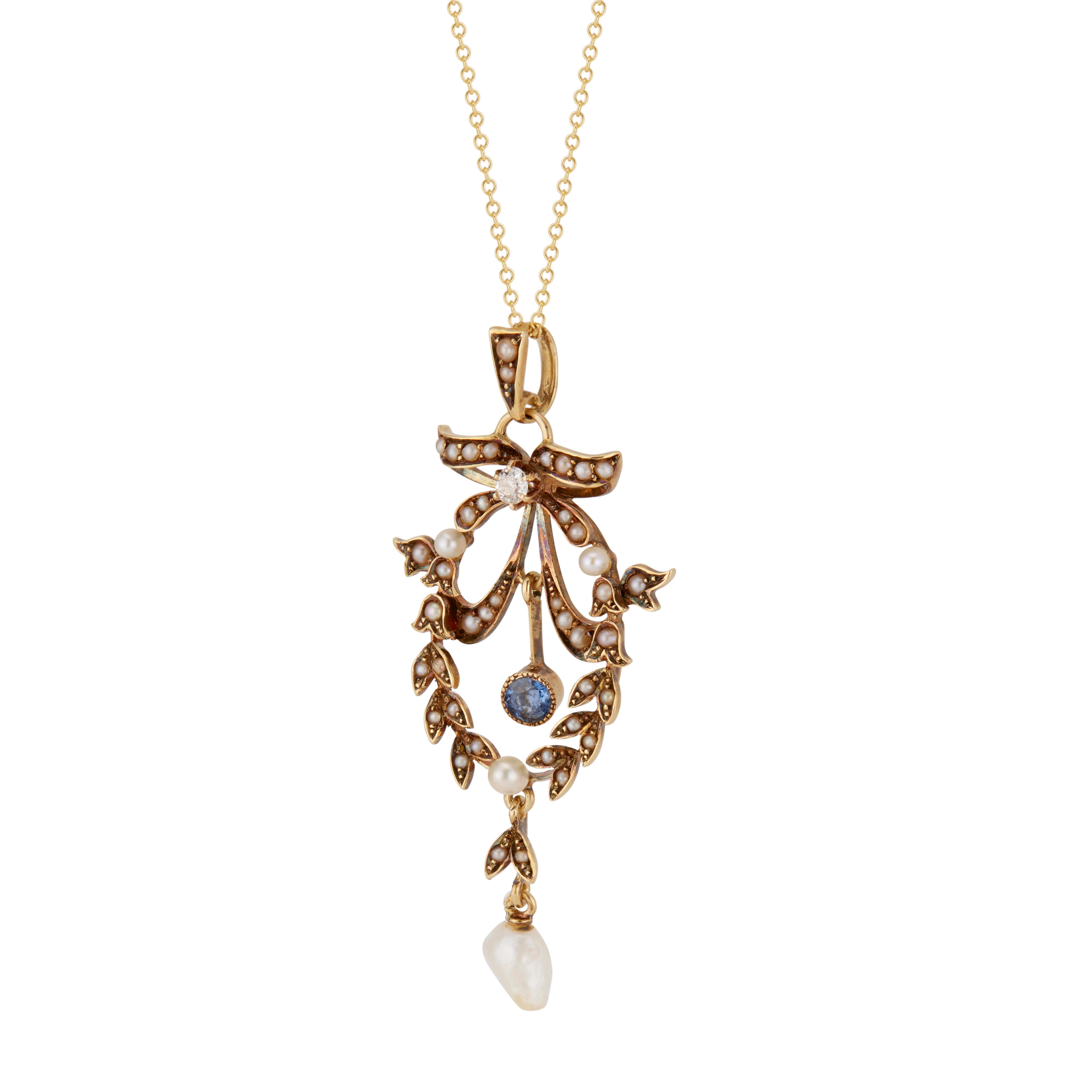 Original 1880's Victorian pendant with bow and wreath design pendant set with 43 natural untreated pearls along with one old cut diamond and one natural sapphire. Natural patina. 18 inch later chain. 

43 natural gray seed pearls
1 natural white