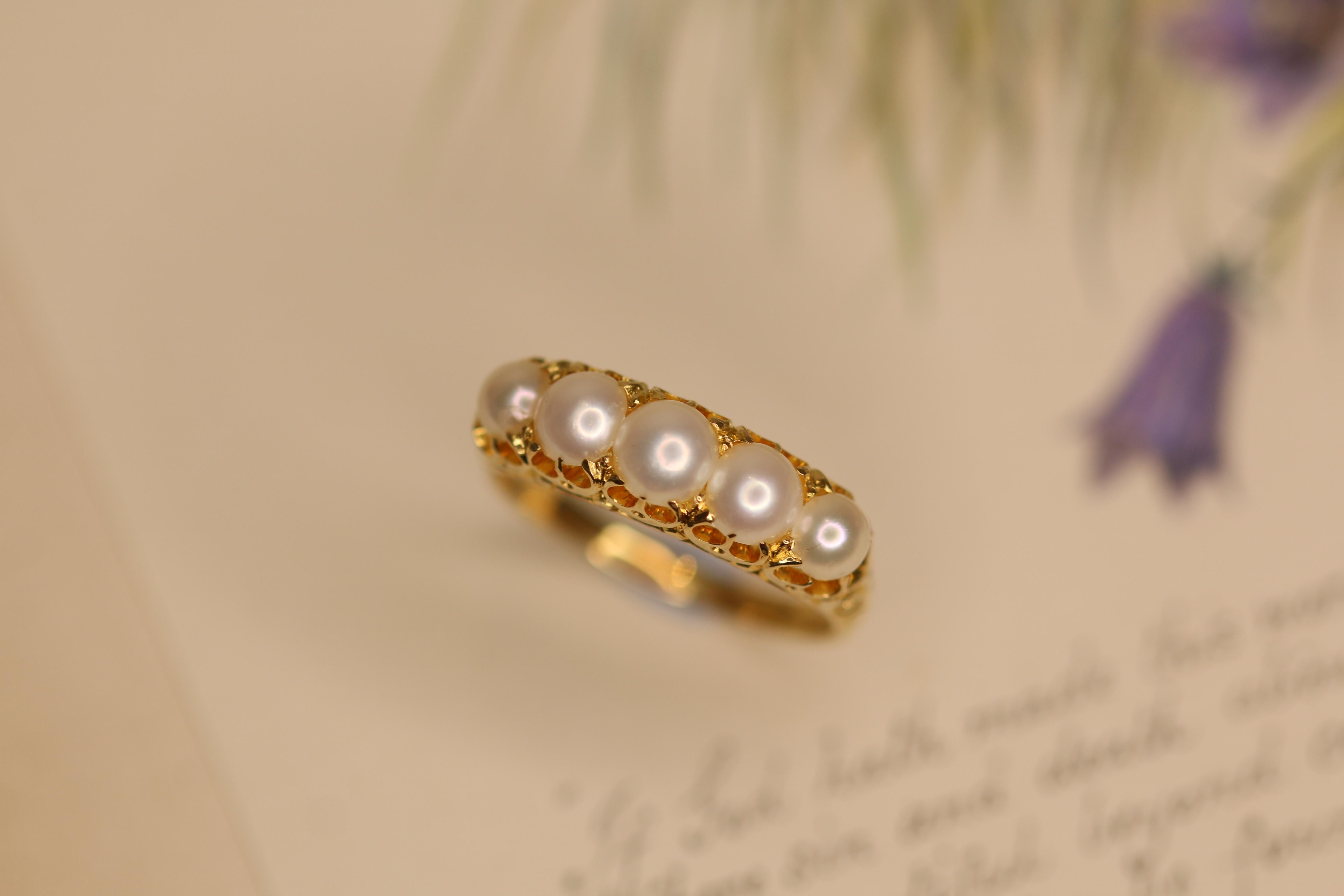 This fabulous Victorian ring is adorned with five lustrous rich creamy pearls. Circa 1900 and steeped in English History.The ring is 18ct yellow gold.The Pearls have a lovely lustre with a rich hue. Looks beautiful when worn. It could be a beautiful