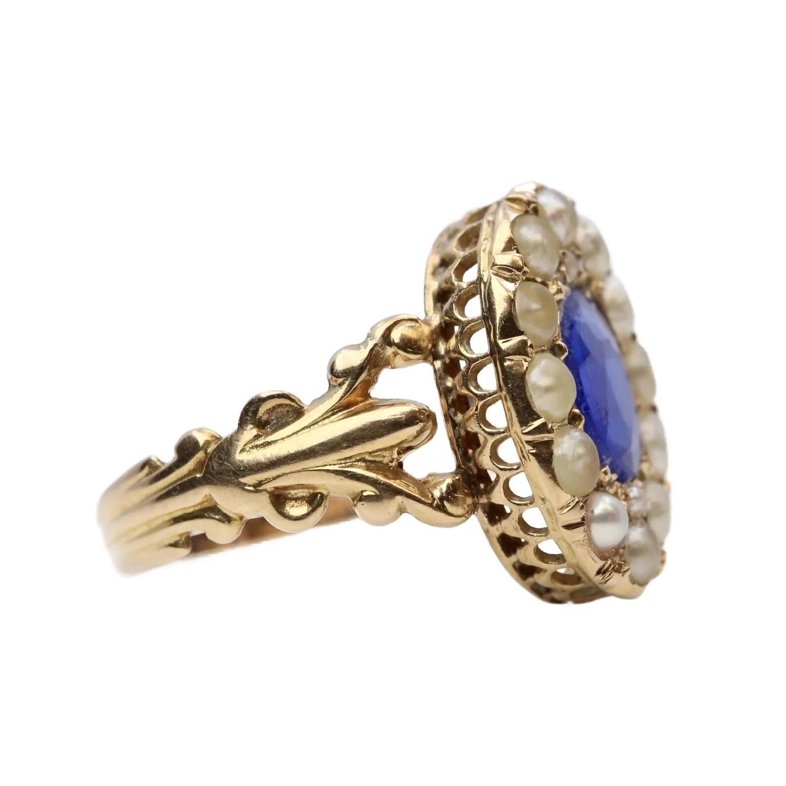 A handmade original victorian period Kyanite, and natural pearl ring in 14 karat yellow gold. Centered by a 1.20 carat rich velvety blue oval cut Kyanite and encircled by fourteen natural half pearls.

In excellent condition, this ring is a size 6