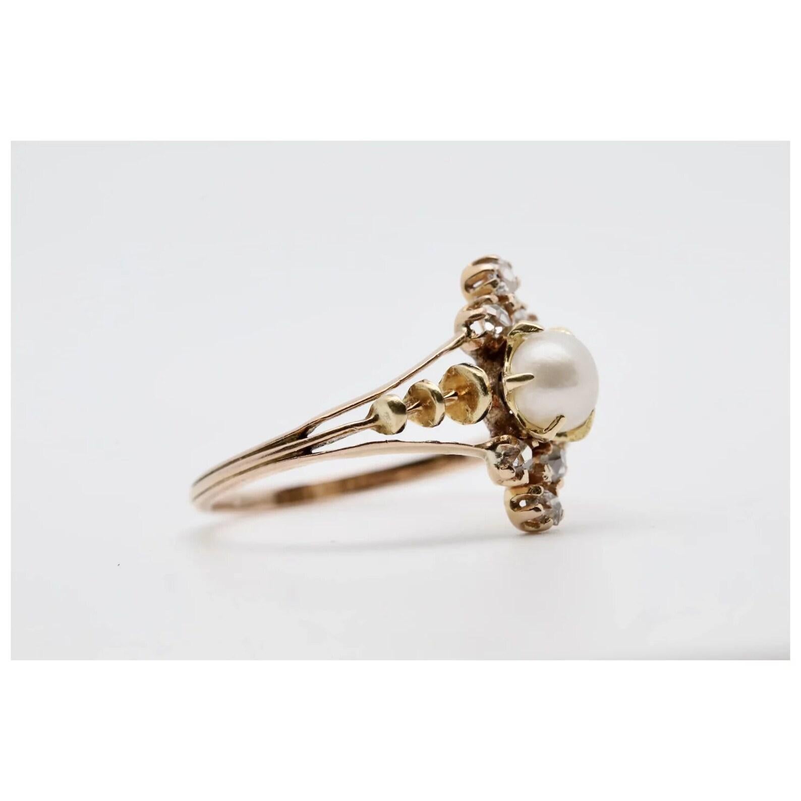 An original victorian period natural pearl and old mine cut diamond ring in 18 karat yellow gold. Centered by a beautiful lustrous 5mm natural saltwater pearl. Framing the pearl are six sparkling old mine cut diamonds weighing a combined 0.18