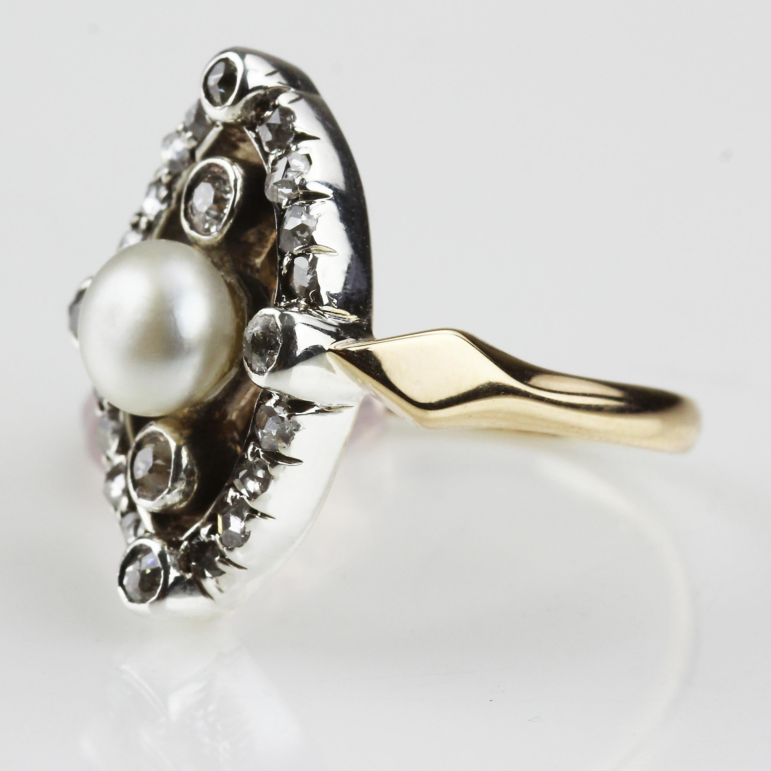Antique Victorian natural pearl center with old European and rose cut diamonds ring. Set in 18 karat yellow gold mount with silver setting for the diamonds, classic Victorian style setting. 
UK ring size 