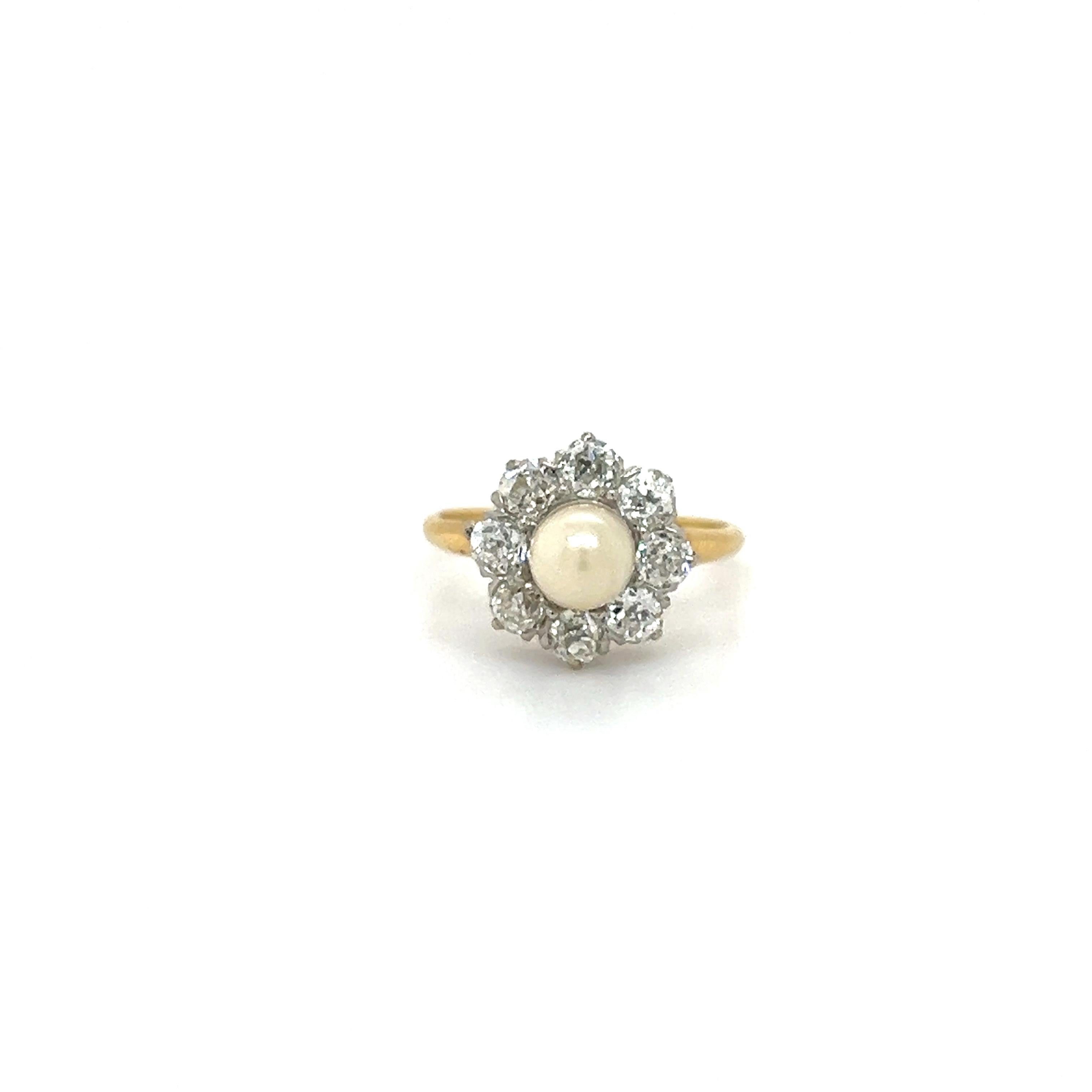 Beautiful ring crafted in 18k yellow gold with a platinum top. The ring is from the Victorian era as it showcases one natural round pearl gemstone with a phenomenal luster. The pearl is surrounded by old mine cut diamonds, eight in total set in a