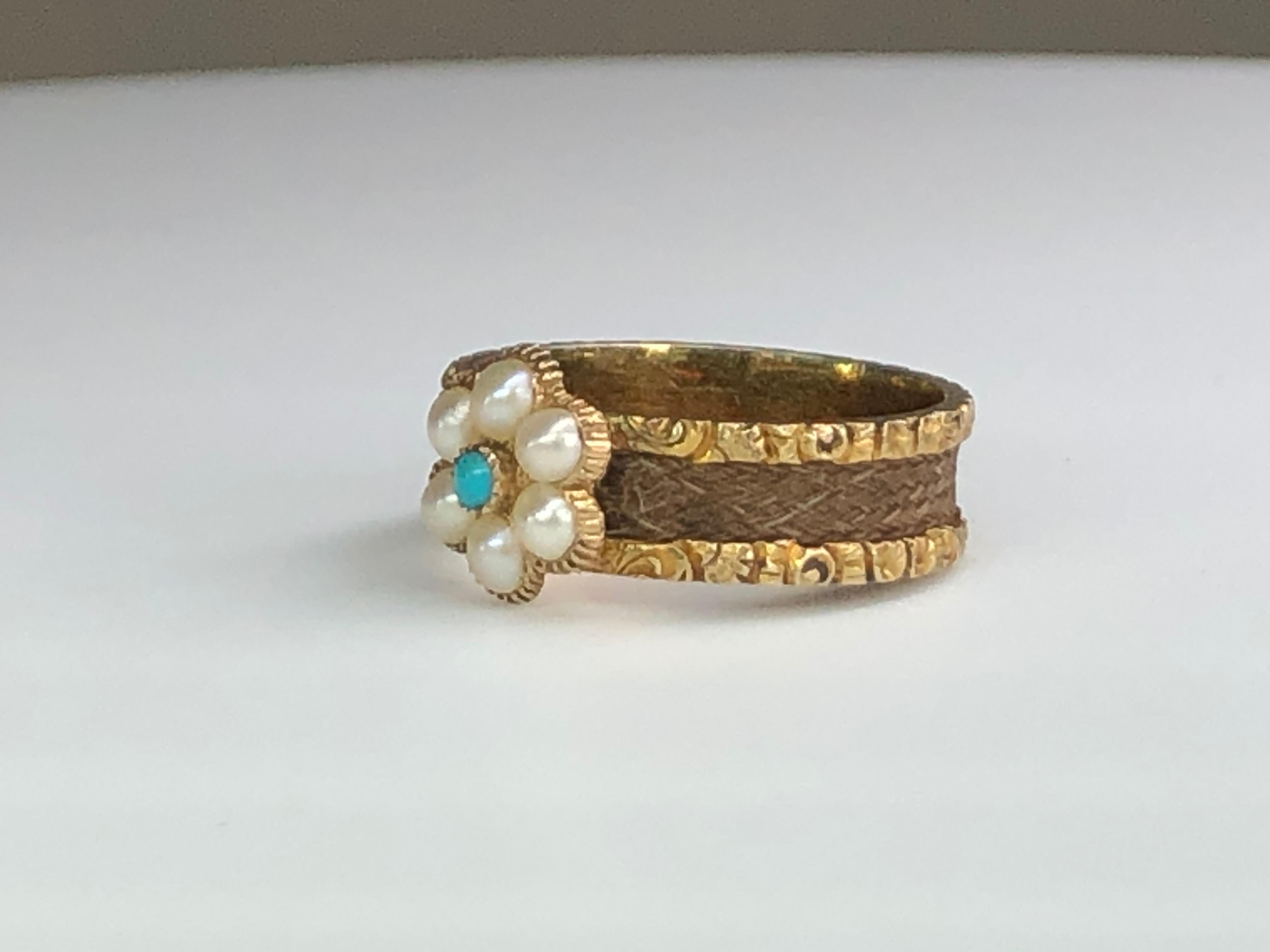This Victorian Pearl & turquoise cluster ring is truly a sight to behold!  We love the daisy flower design with the beautifully engraved gold shoulders.  Such an elegant piece, this ring exudes charm and class on all occasions.

This ring is a