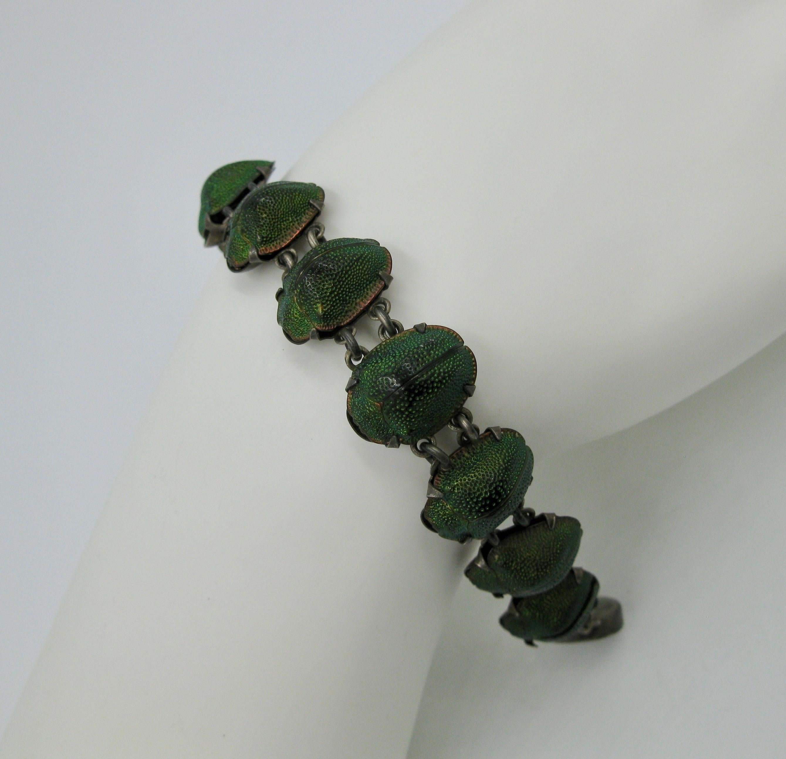 This is a very rare and wonderful antique Victorian Egyptian Revival Bracelet with 11 Natural Iridescent Green Scarab Beetles set in Sterling Silver. The jewel an Egyptian Revival piece dating to circa 1860 - 1930.  Very rare to find these bracelets