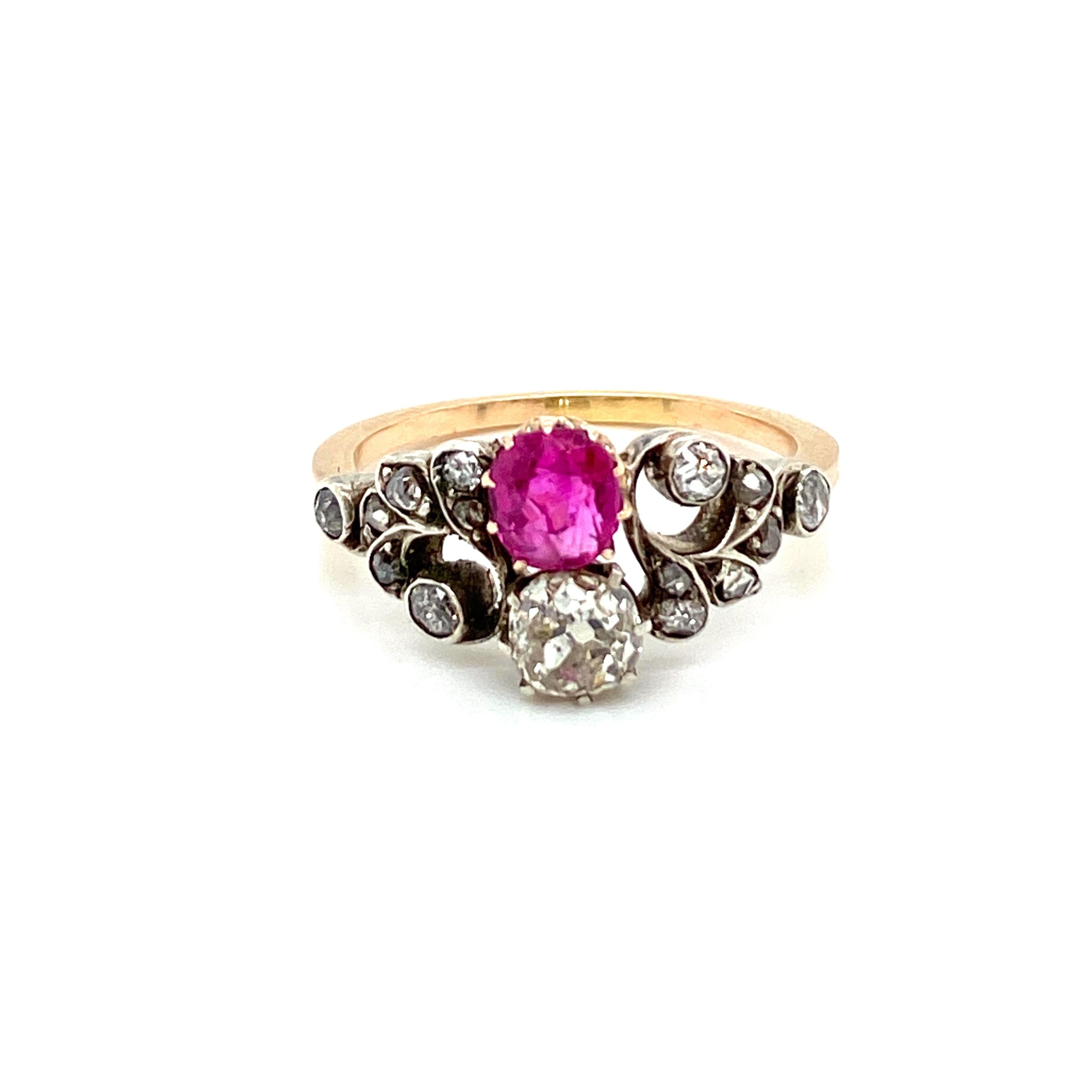 This Beautiful Authentic Victorian 12k gold and silver 'Vous et Moi' ring is set in the center with one vivid Natural unheated Ruby, 0,80 ct., and one Sparkling Old mine cut diamond weighing approx. 0.70 ct., graded H-I color Vs2.  The flower design