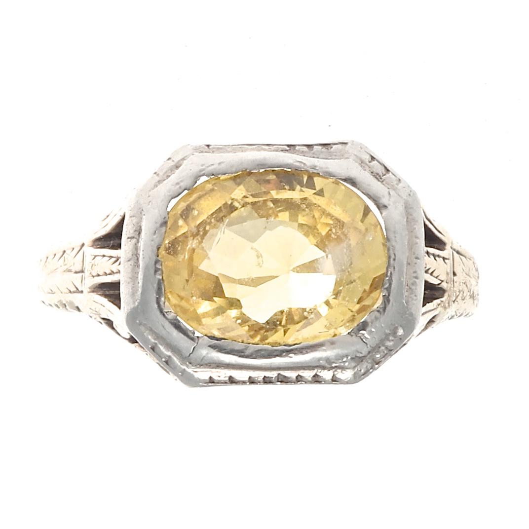 Reminiscent of the growing happiness and prosperity during Queen Victorias reign. Featuring an approximately 4 carat vibrantly shinning natural yellow sapphire. Bezel set in a beautifully engraved 18k gold ring. Size 9-1/2 and can easily be resized