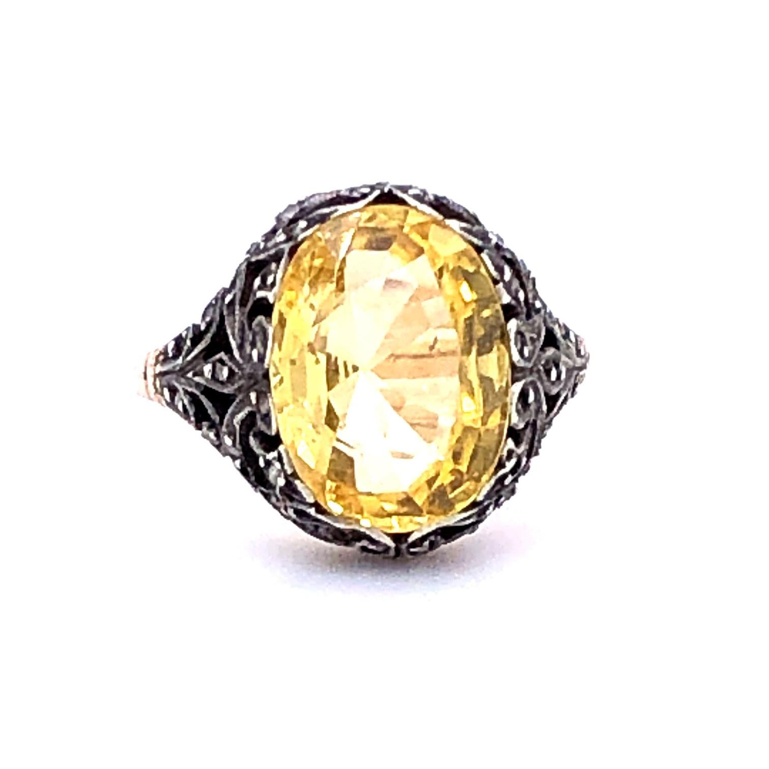An intricate Victorian Natural Yellow Sapphire Ring, ca. 1880s, set with a bright yellow unheated yellow sapphire of ca. 4.8 carats. The sapphire is set within a very detailed floral metal cluster.

Ring size 4, can be altered complimentary upon