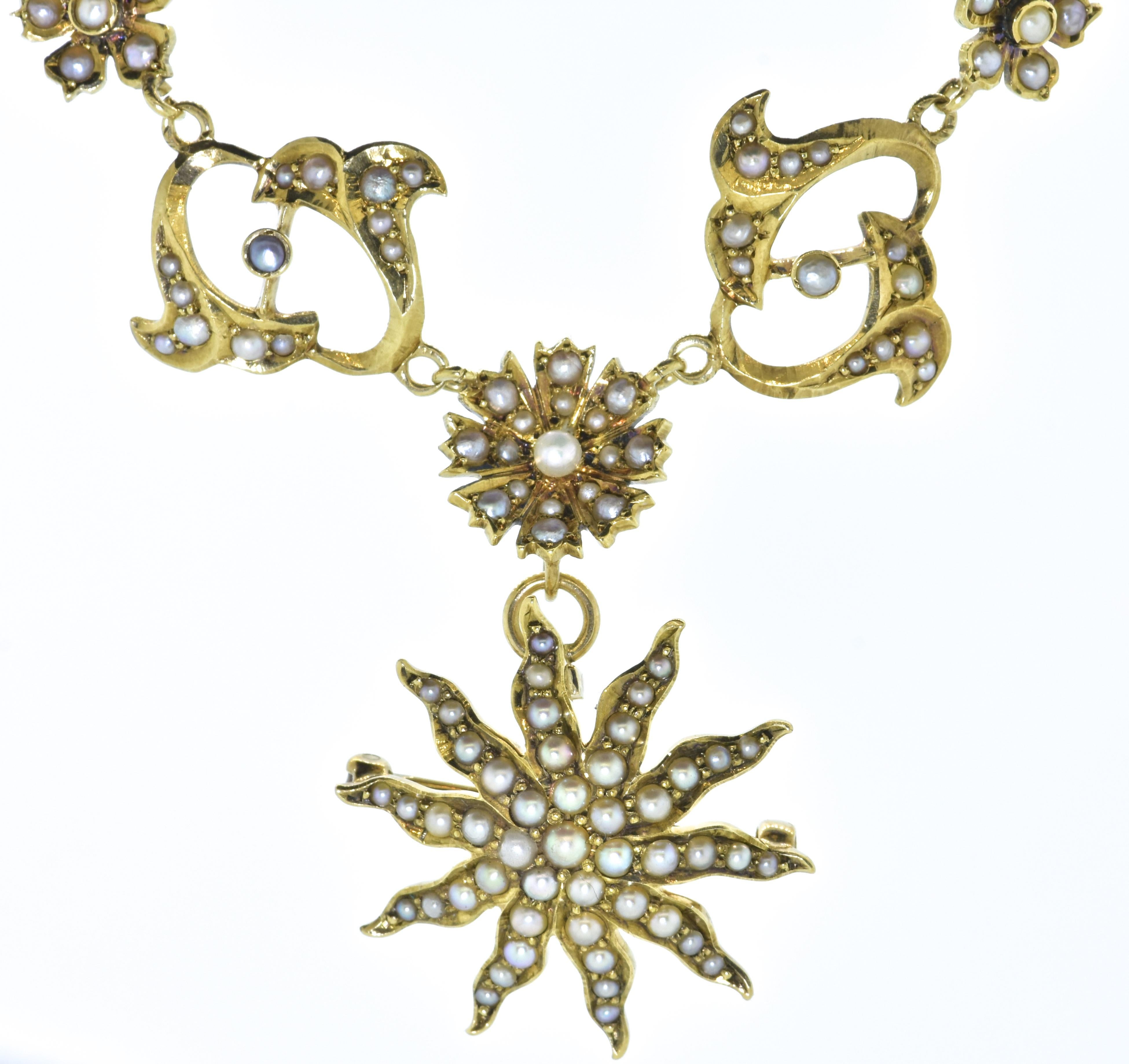 Antique necklace/brooch set throughout with natural seed pearls.  This yellow gold necklace suspends a matching comet/star motif pendant which can also be worn separately as a brooch.  The ornate necklace of flower and vines is very feminine and