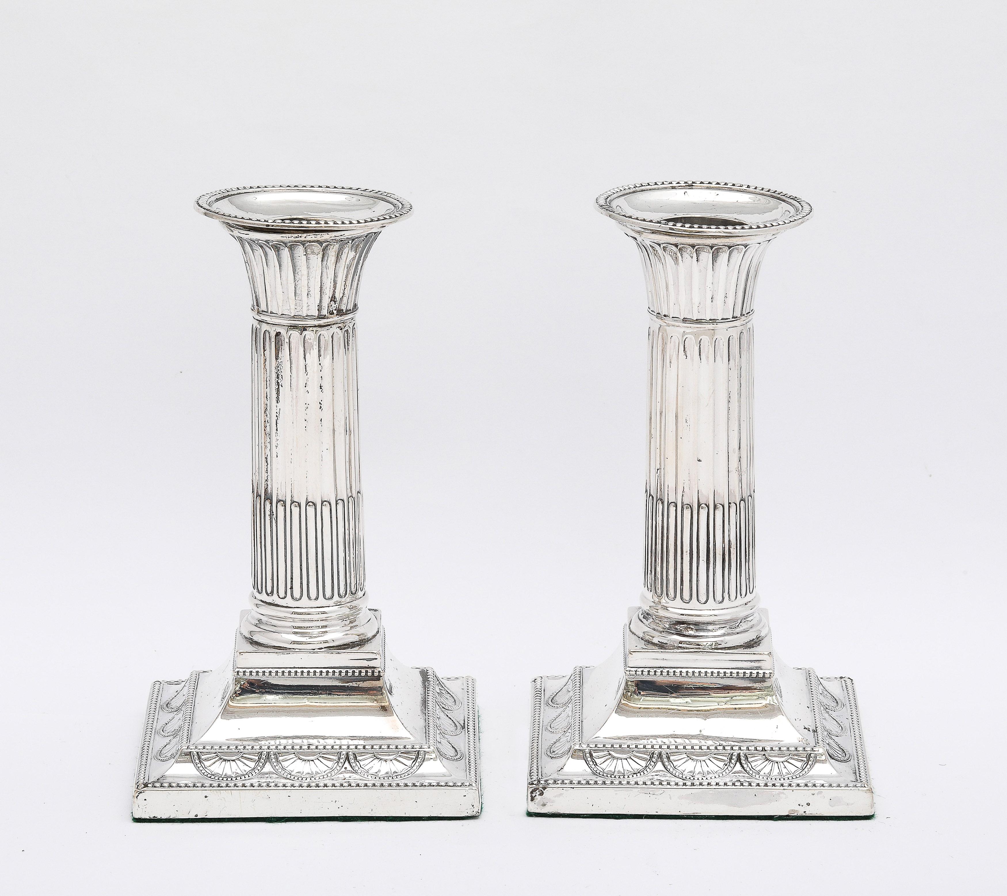 Neoclassical-style, Victorian Period, sterling silver candlesticks, London, year-hallmarked for 1895, William Hutton and Sons - Makers. Each candlestick measures 3 inches wide (at widest point) x 3 inches deep (at deepest point) x 5 1/2  inches high