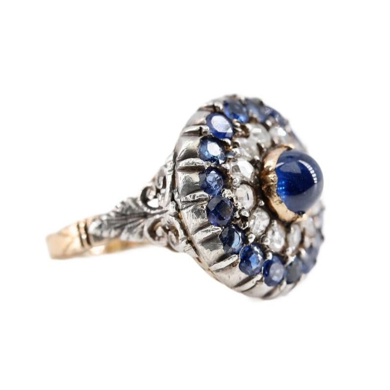 Aston Estate Jewelry Presents:

A victorian period No Heat Burmese sapphire, and diamond ring in 14 karat yellow gold. Centered by a 1.52 carat natural, No heat cabochon cut sapphire of Burmese origin set in a bezel of yellow gold. Framing the