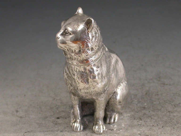 A fine quality Victorian novelty cast silver pepper formed as a seated collared cat, with pull off pierced head and silver gilt interior.

By E H Stockwell, London, 1876

In good condition with no damage or repair, minor loss of interior