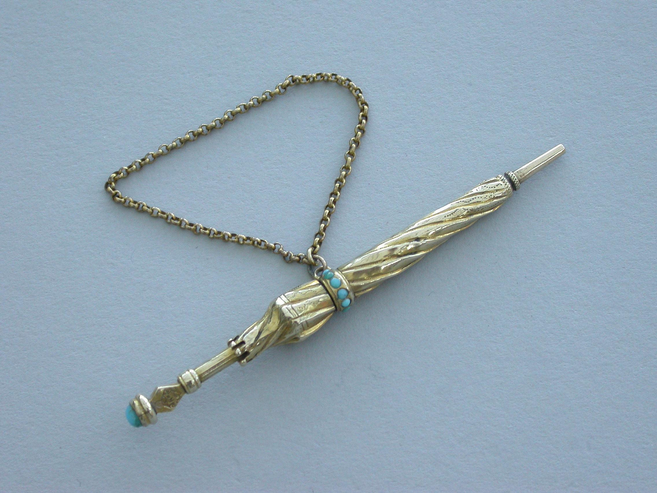 A good Victorian novelty gold Propelling Pencil made in the form of a furled umbrella, decorated with turquoise beads and with attached suspension chain. A twist-action mechanism to open.

Unmarked, but stamped with a diamond registration mark for