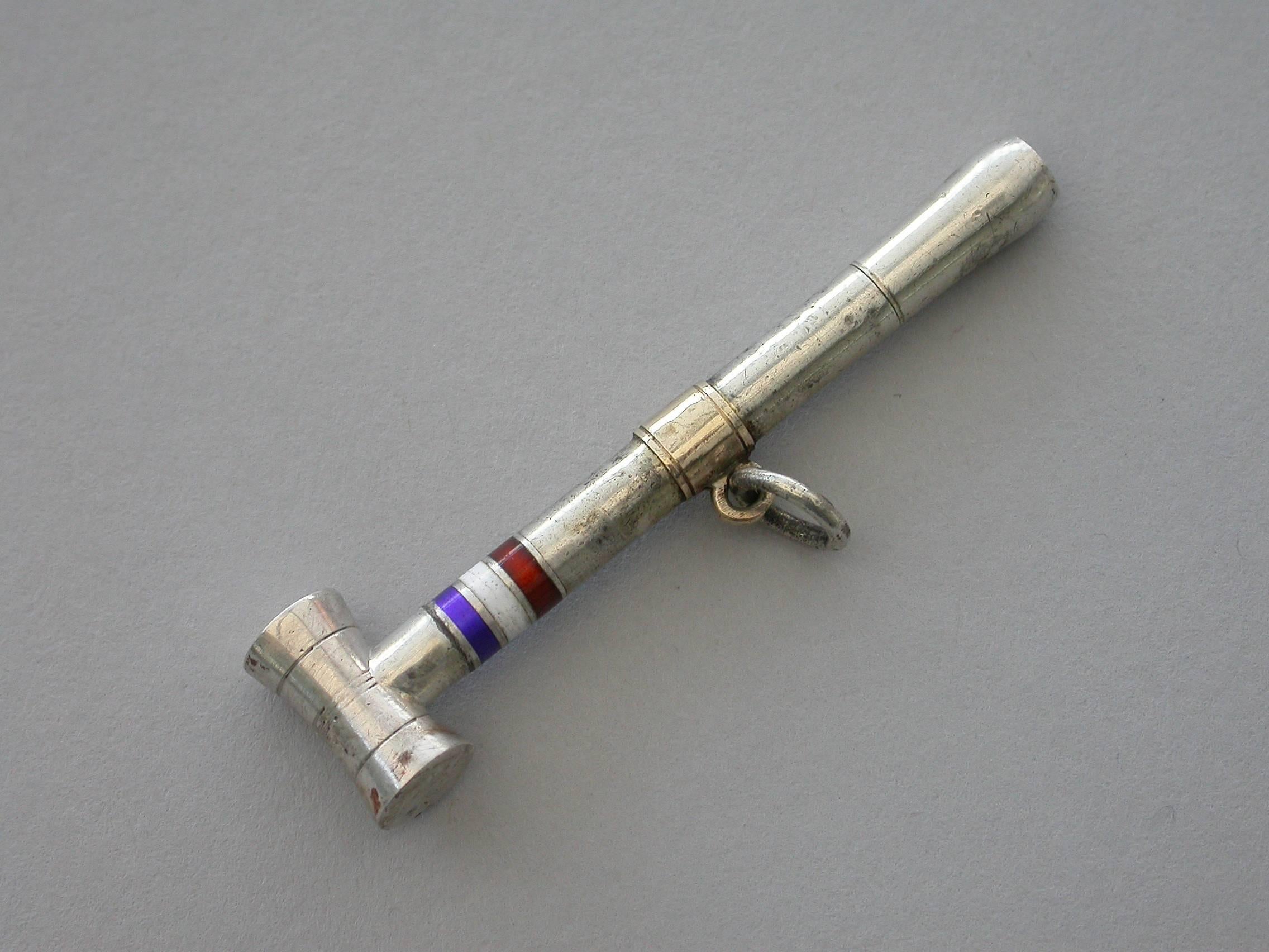 A rare Victorian novelty silver propelling pencil made in the form of a croquet mallet with blue, red and white enamel bands to the shaft. A twist action to propel the pencil. Suspension ring attached to gold collar.

By Sampson Mordan & Co