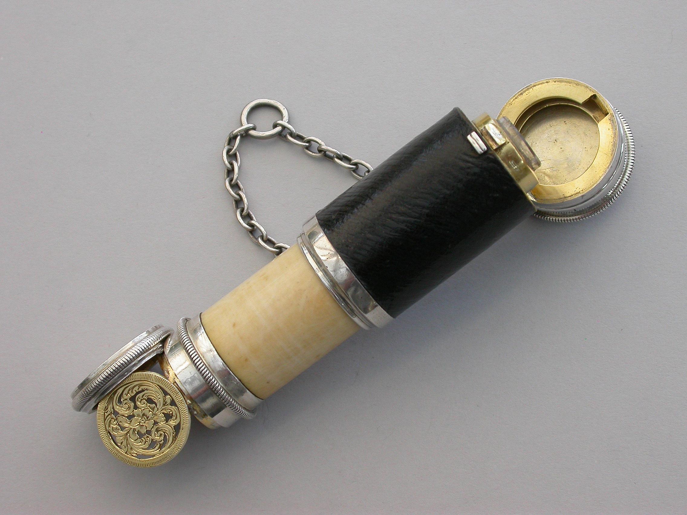 A fine quality and extremely rare novelty silver combined Scent Bottle and Vinaigrette made in the form of a telescope with attached chain and suspension ring, the middle of the outer body covered in leather and the inner sleeve formed from bone.